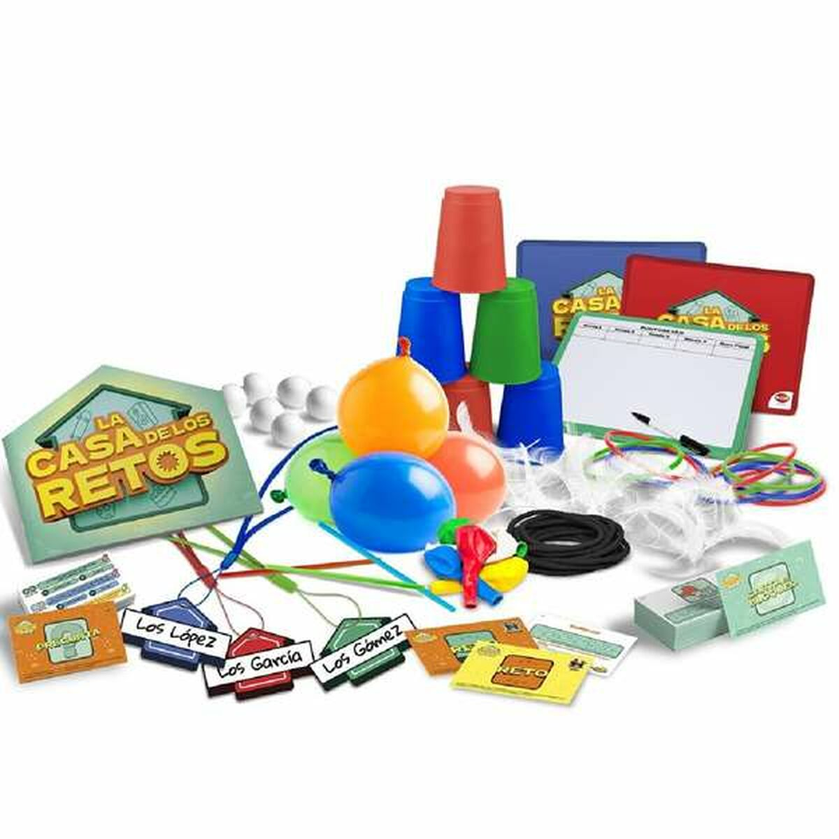 Un juego con vasos, globos, cartas y otros objetos. El juego tiene un logotipo de casa y texto en español. Los colores incluyen rojo, azul y verde.