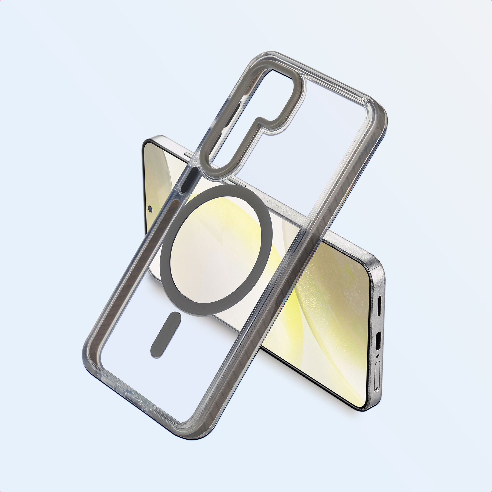 Un telefono con una custodia trasparente. La custodia ha un bordo grigio e un magnete circolare. Il telefono è argentato.