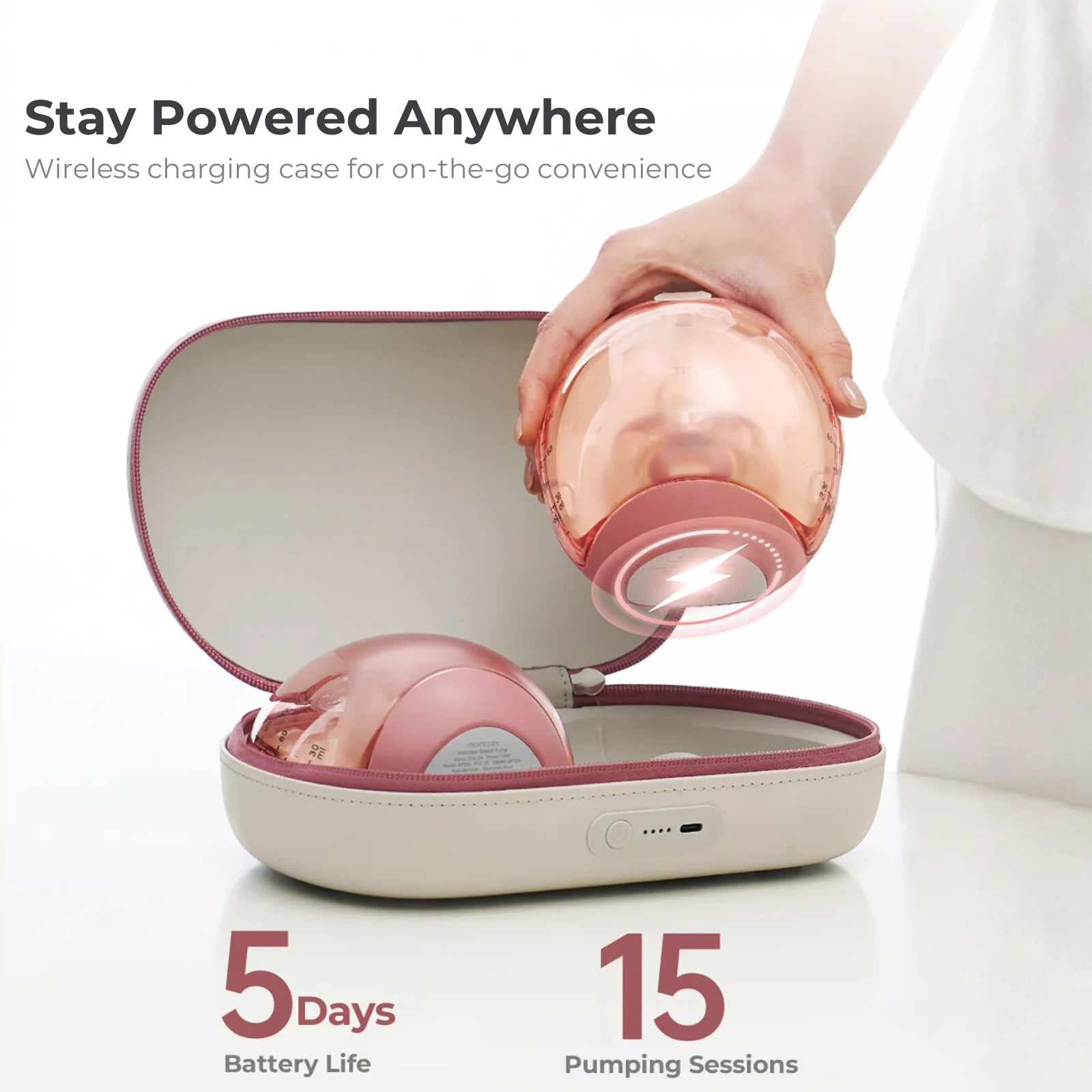 A woman's hand holds a pink breast pump, over an open case. Text: Stay Powered Anywhere, 5 days battery, 15 sessions.