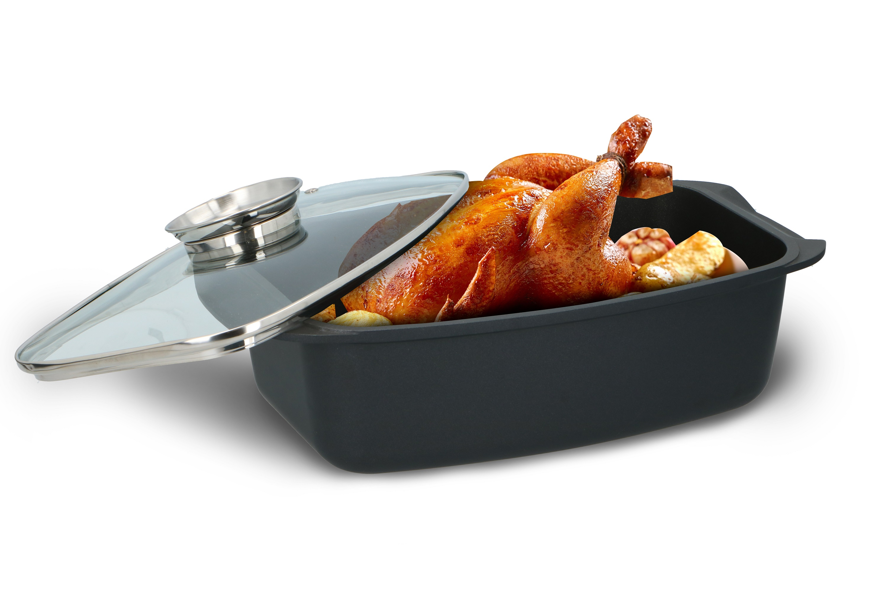 Roasted chicken in a black dish with a glass lid, potatoes and garlic on a white background.