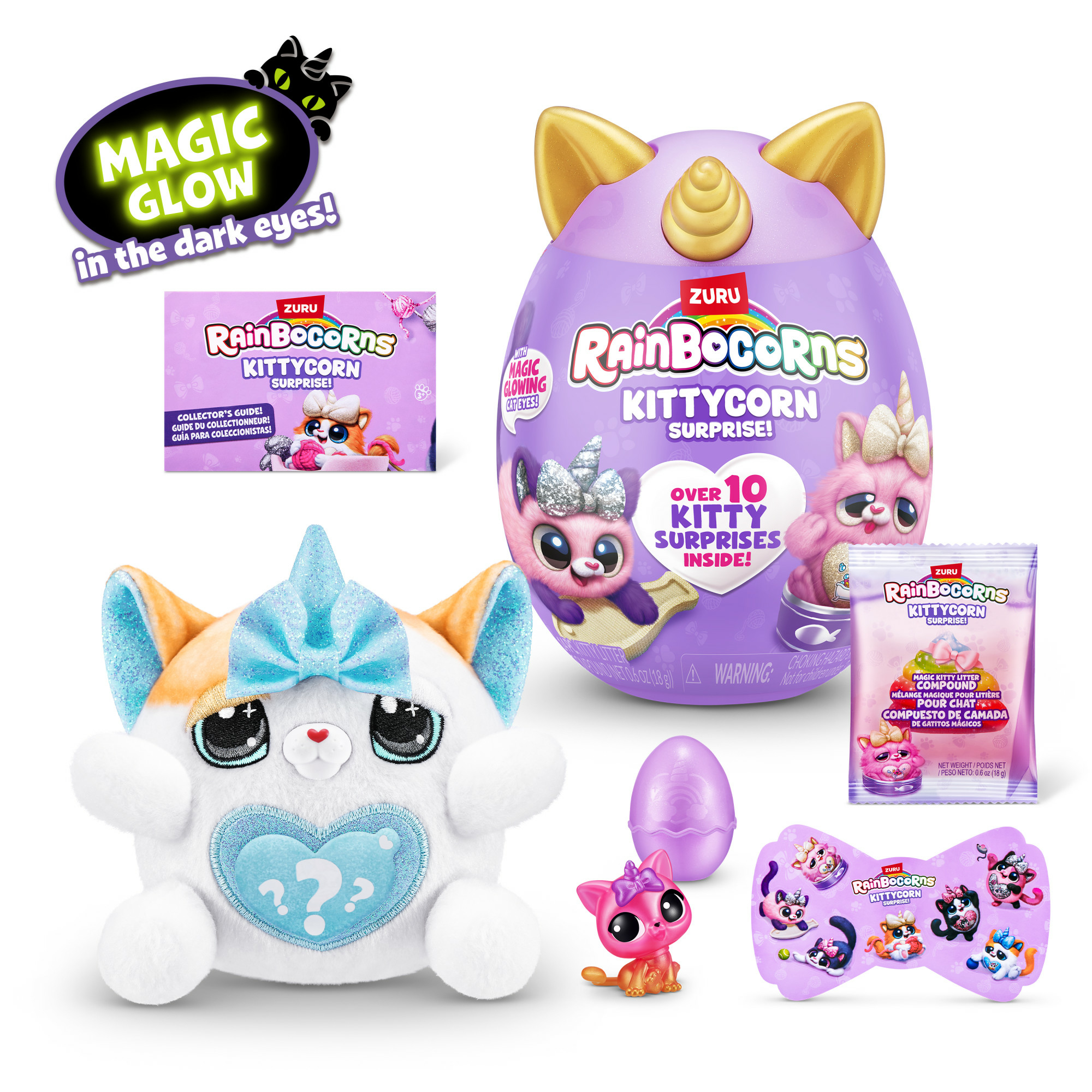 Das Bild zeigt Rainbocorns Kittycorn-Spielzeuge, darunter ein Plüschtier, einen eiförmigen Behälter und kleine Figuren. Die Spielzeuge sind bunt und katzenförmig.