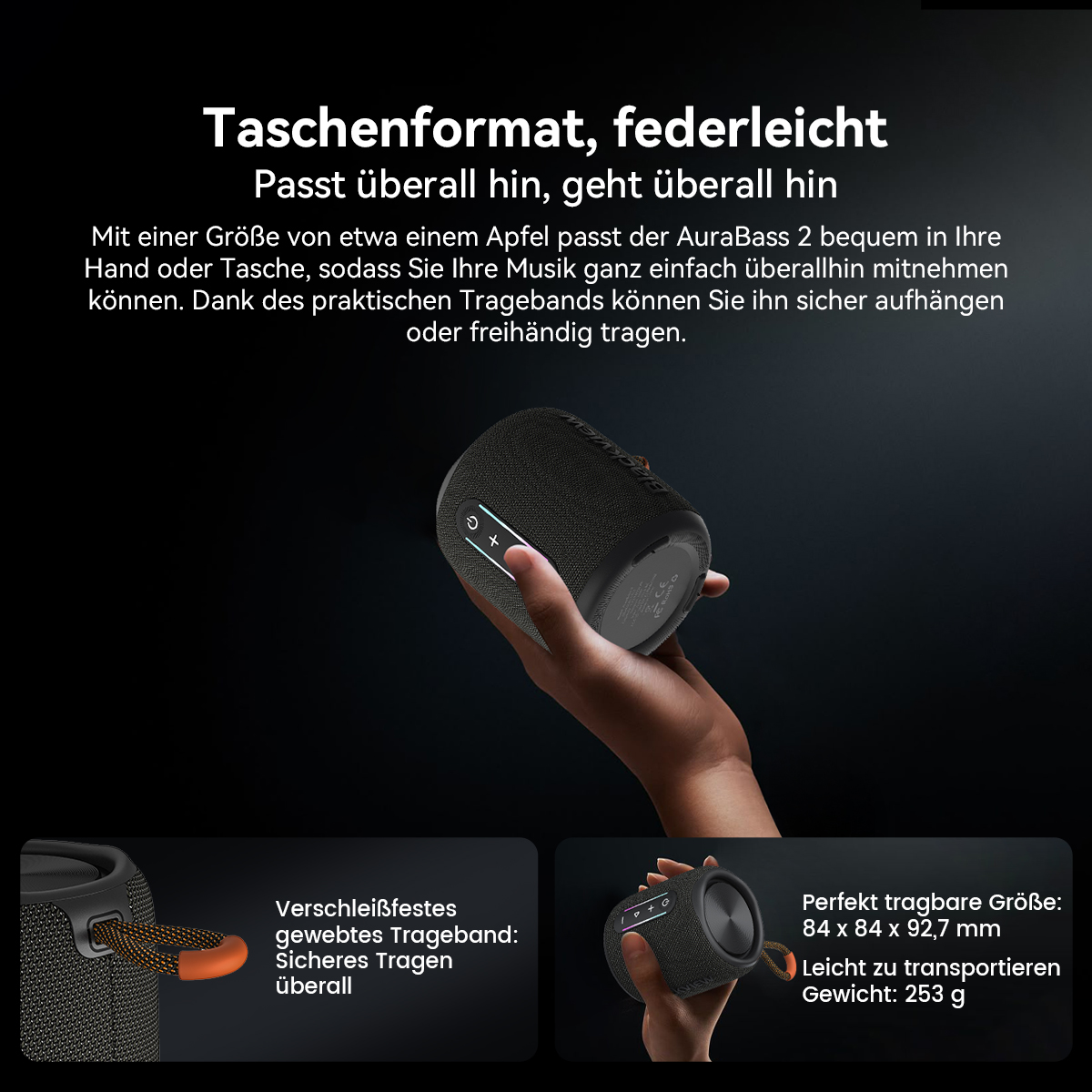 Eine Hand hält einen schwarzen Lautsprecher. Text besagt, dass er tragbar ist und einen Tragegurt hat.
