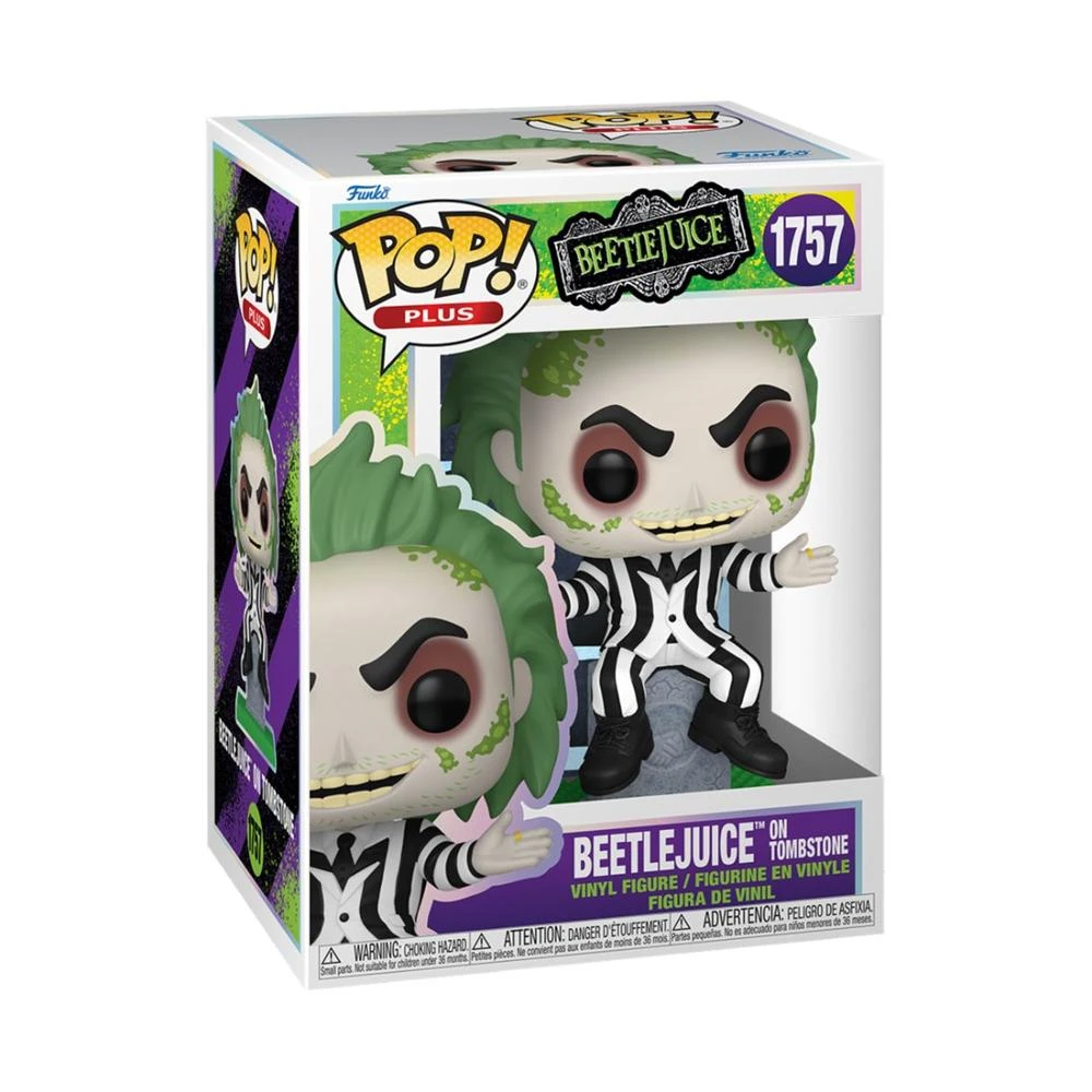 Una figura di Beetlejuice Funko Pop su una lapide dentro una scatola. La figura indossa un abito a righe bianche e nere con i capelli verdi.