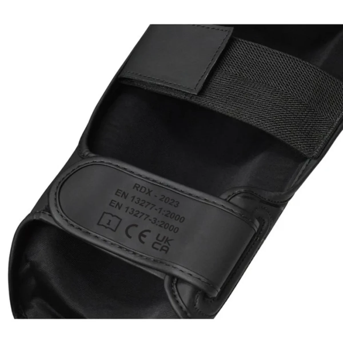 Schwarze Schutzkleidung mit Riemen und Etiketten. Enthält RDX-2023, EN 13277-1:2000 und EN 13277-3:2000.