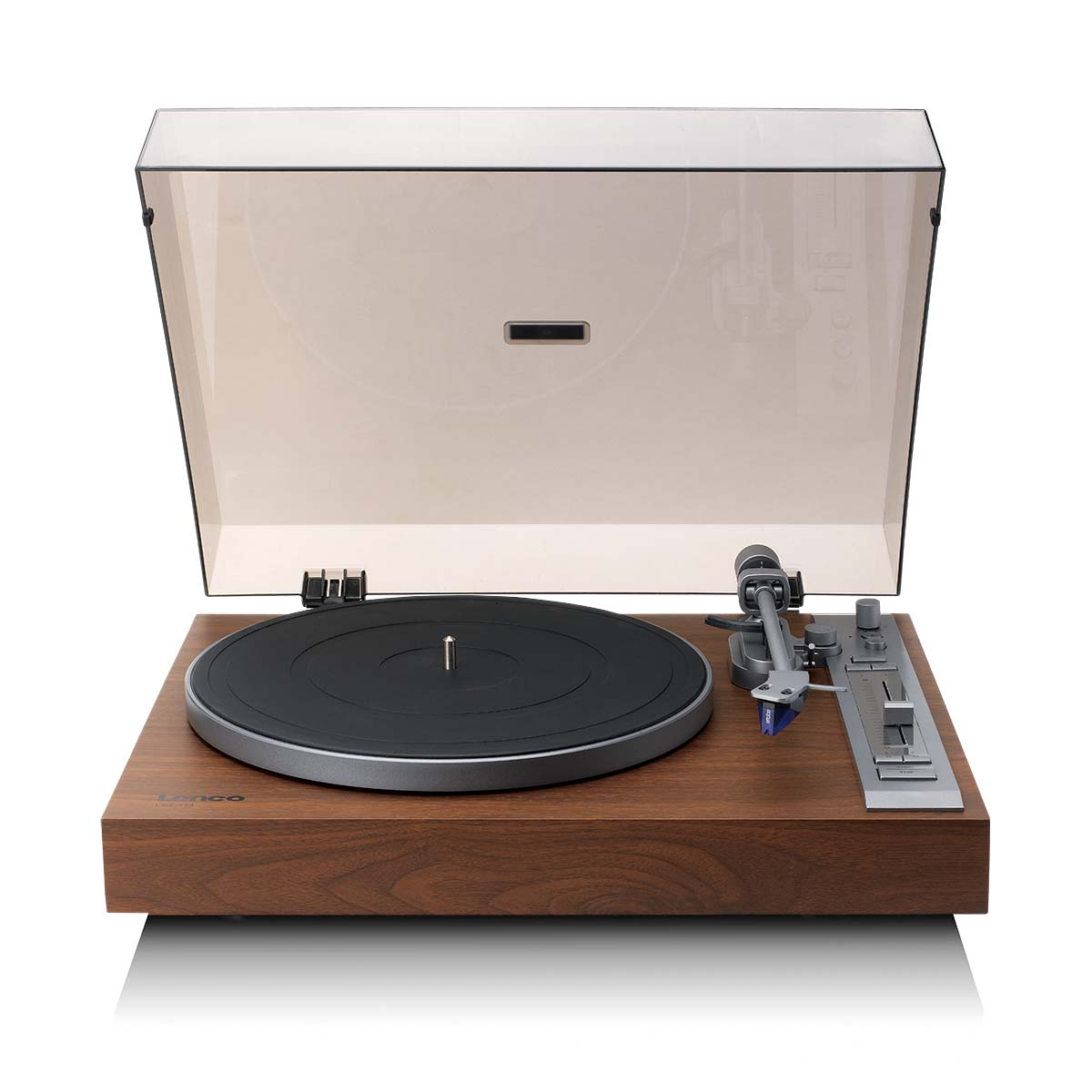 A turntable with a wooden base, black record, silver arm and a clear plastic cover. Controls on the right.