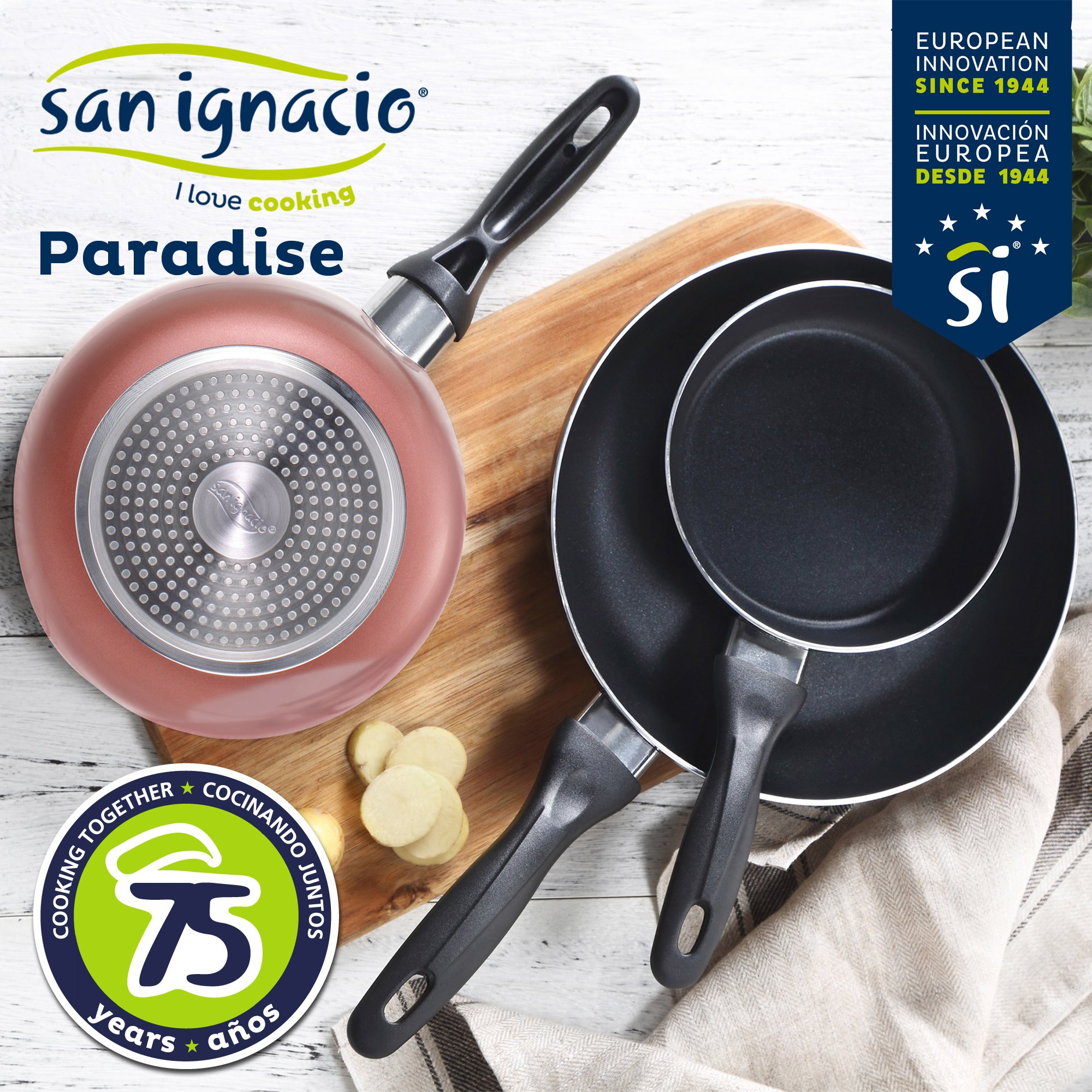 La imagen muestra sartenes sobre una tabla de madera. La marca incluye 'San Ignacio' y 'Paradise'.