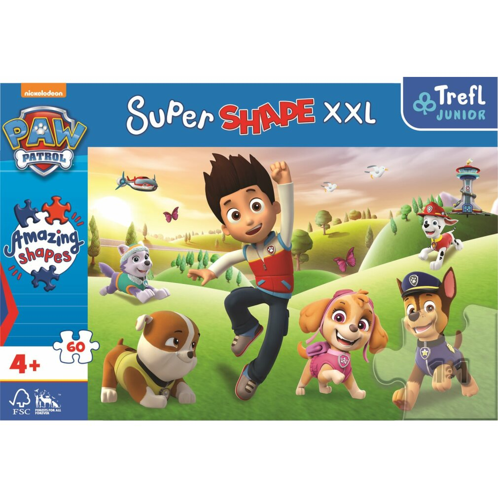 Un puzzle Paw Patrol. Ryder et les chiots sont dans un champ vert. Le puzzle est étiqueté 'Super Shape XXL' et 'Amazing Shapes'.