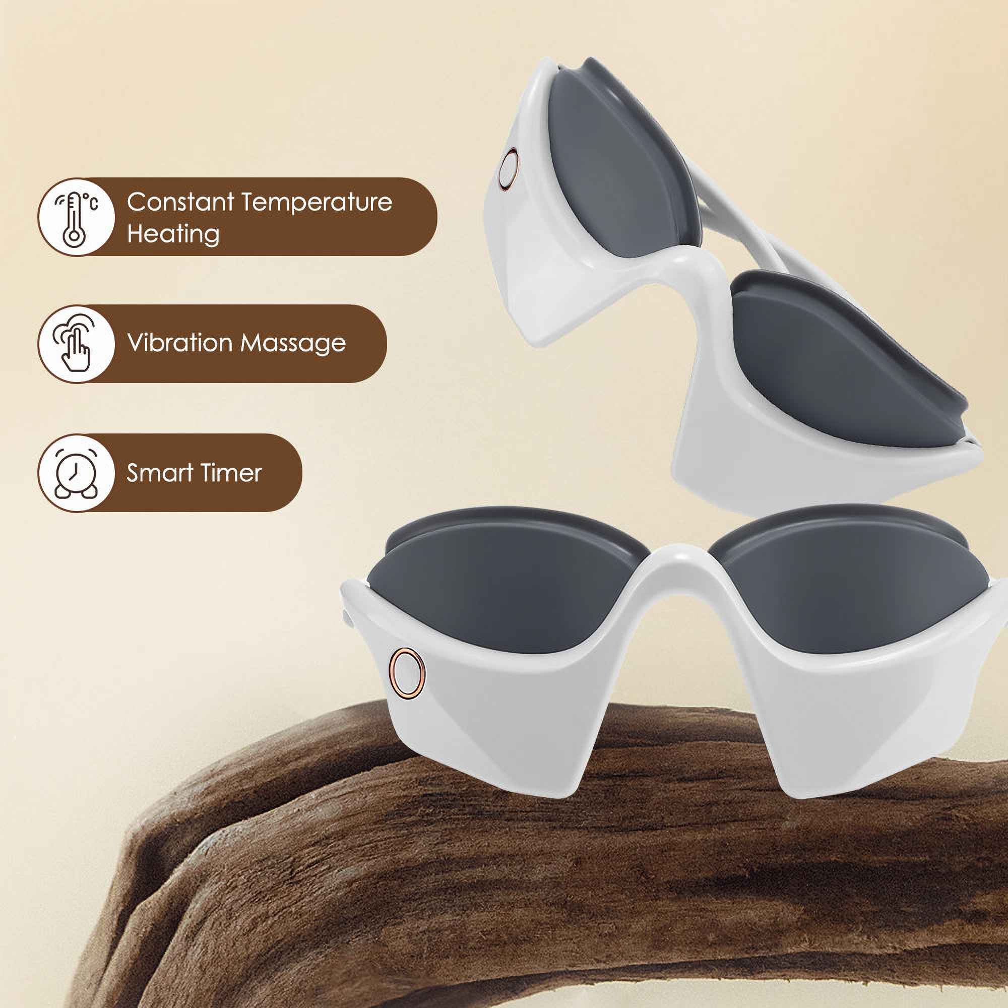 Weißes Augenmassagegerät mit dunkelgrauen Gläsern auf Holz. Merkmale: konstante Heizung, Vibrationsmassage und Smart-Timer.