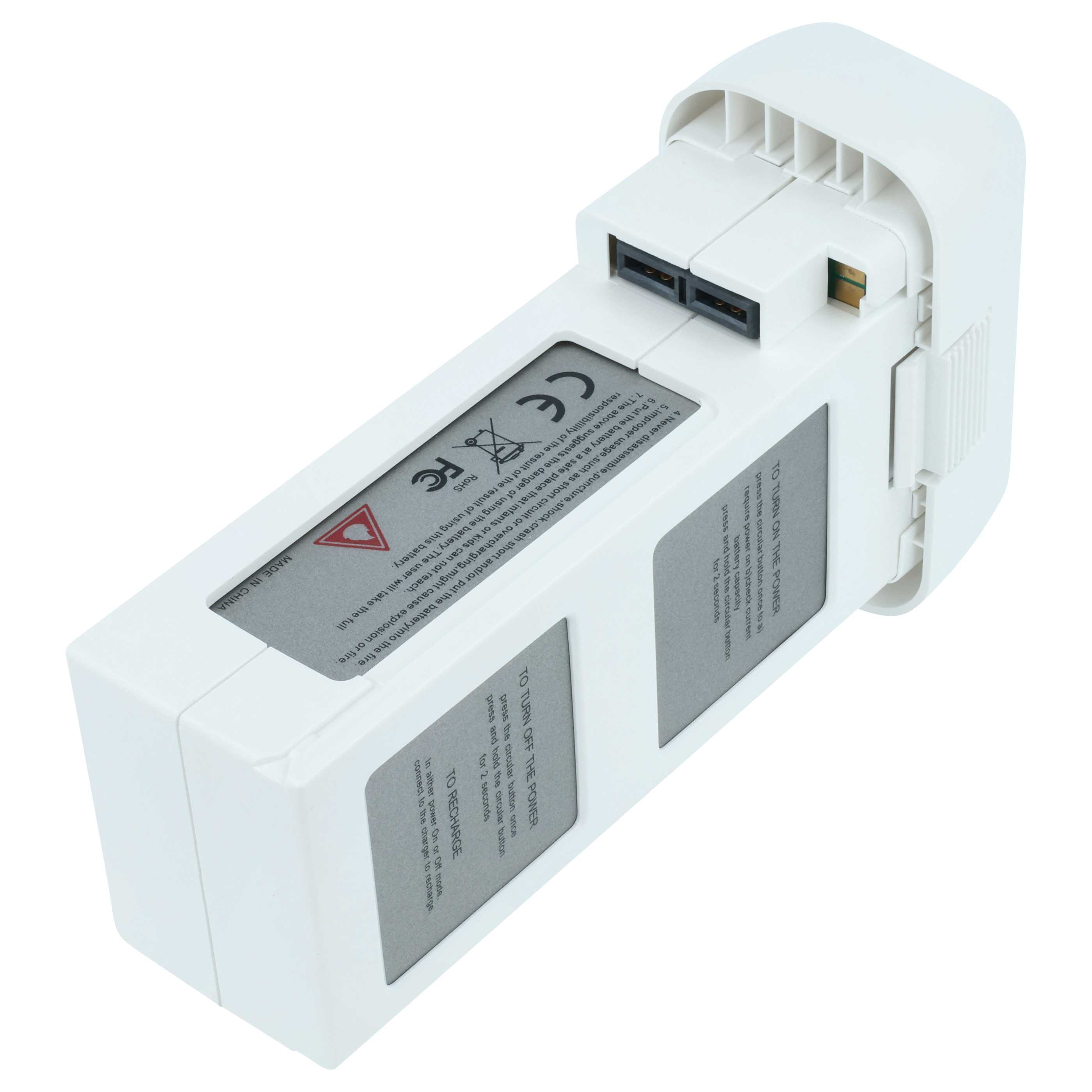 Weiße Drohnenbatterie mit Etiketten und Anweisungen, schräge Ansicht. Enthält CE- und RoHS-Kennzeichnungen.