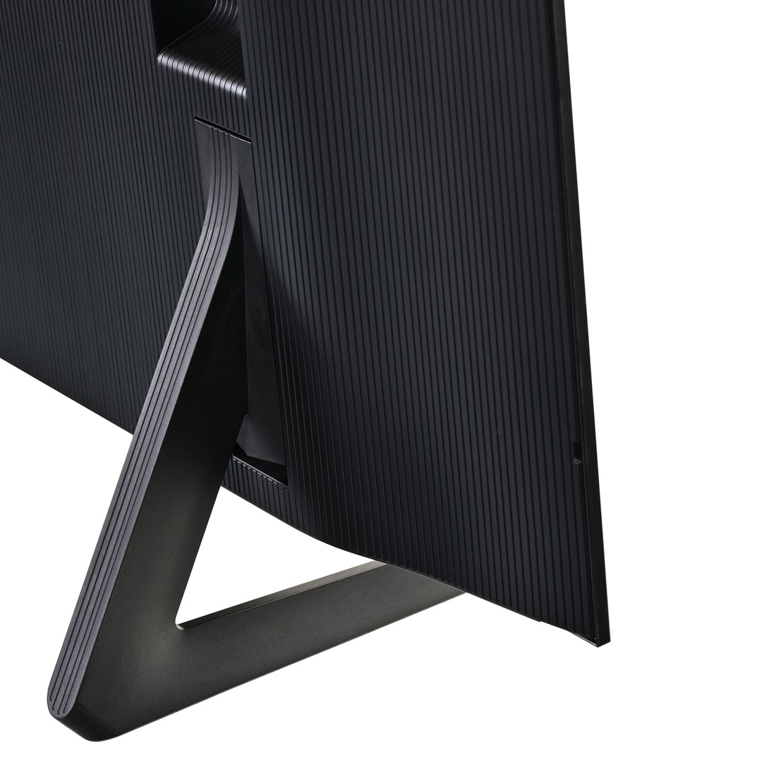 Primer plano de un monitor de computadora negro. El monitor tiene una textura acanalada en la parte posterior. Un soporte negro sostiene el monitor.