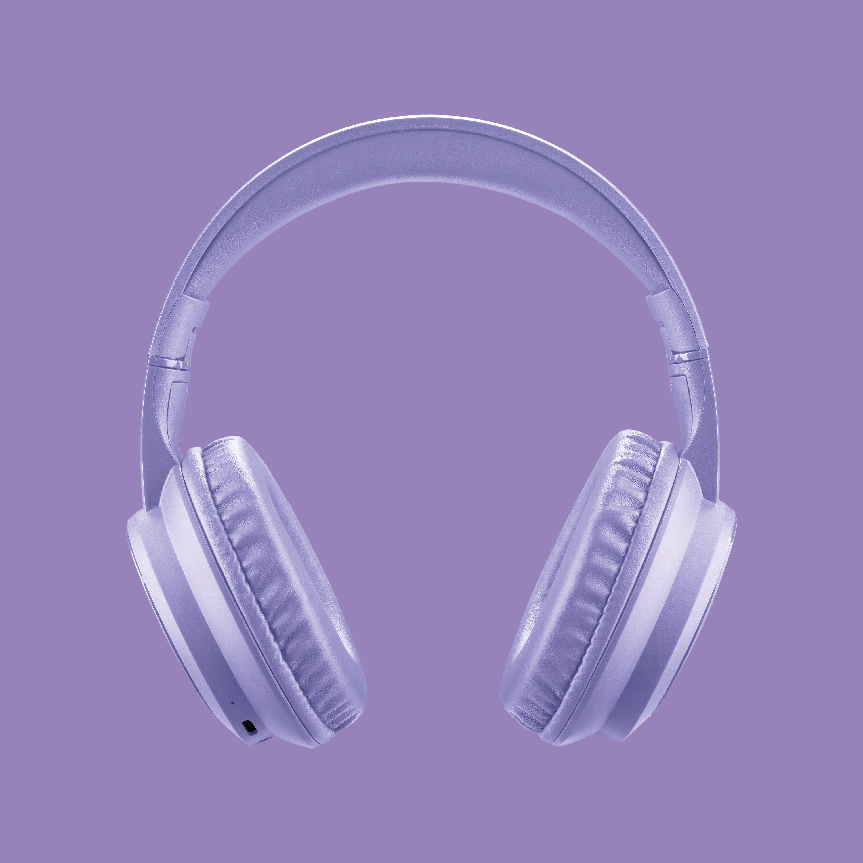 Un paio di cuffie lavanda su sfondo lavanda. Le cuffie sono centrate e a fuoco.