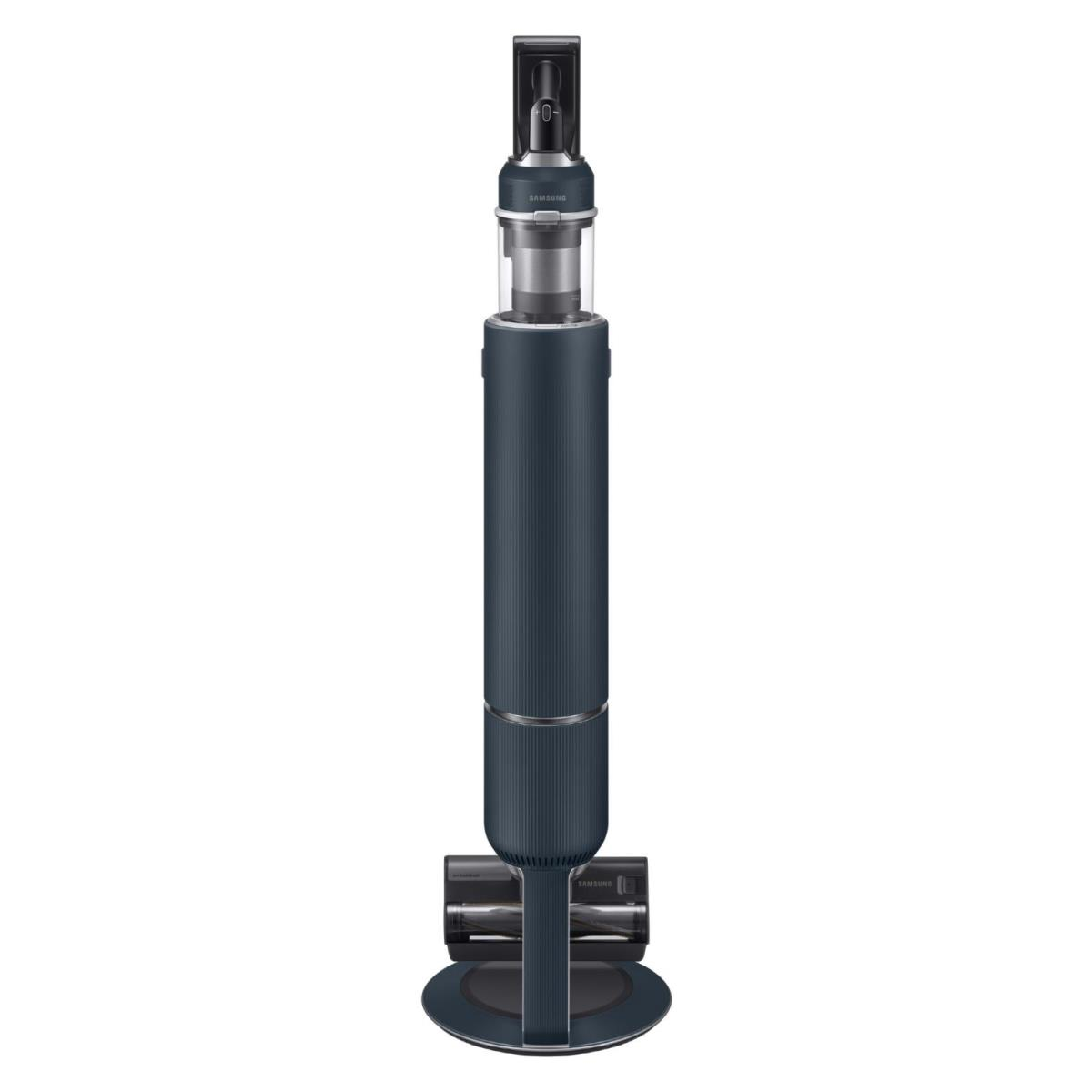 Granatowy odkurzacz bezprzewodowy stoi pionowo. Ma długi cylindryczny korpus, przezroczysty pojemnik na kurz i głowicę szczotkową.