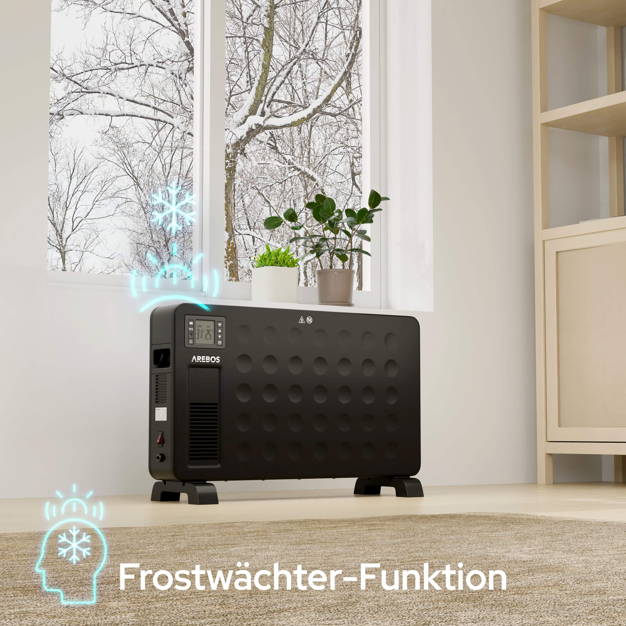 Ein schwarzer Arebos-Heizkörper steht in der Nähe eines Fensters mit verschneiter Aussicht. Pflanzen stehen oben. Frostschutzfunktion.