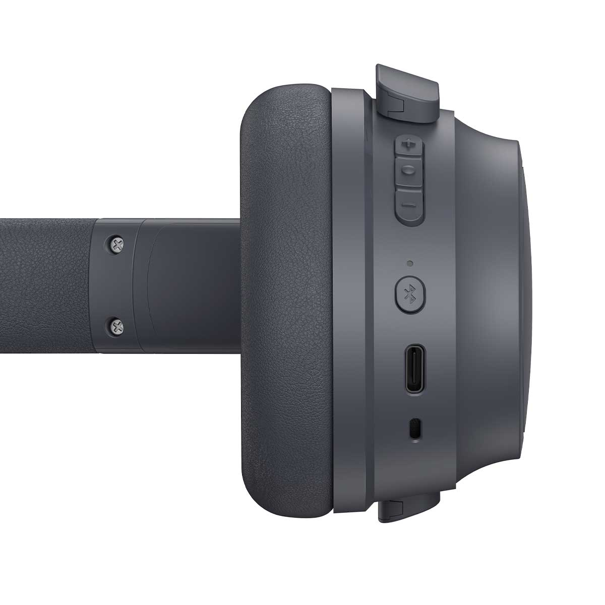 Un primo piano di un'auricolare wireless grigia. L'auricolare ha un padiglione auricolare imbottito e pulsanti sul lato. È posto su uno sfondo bianco.