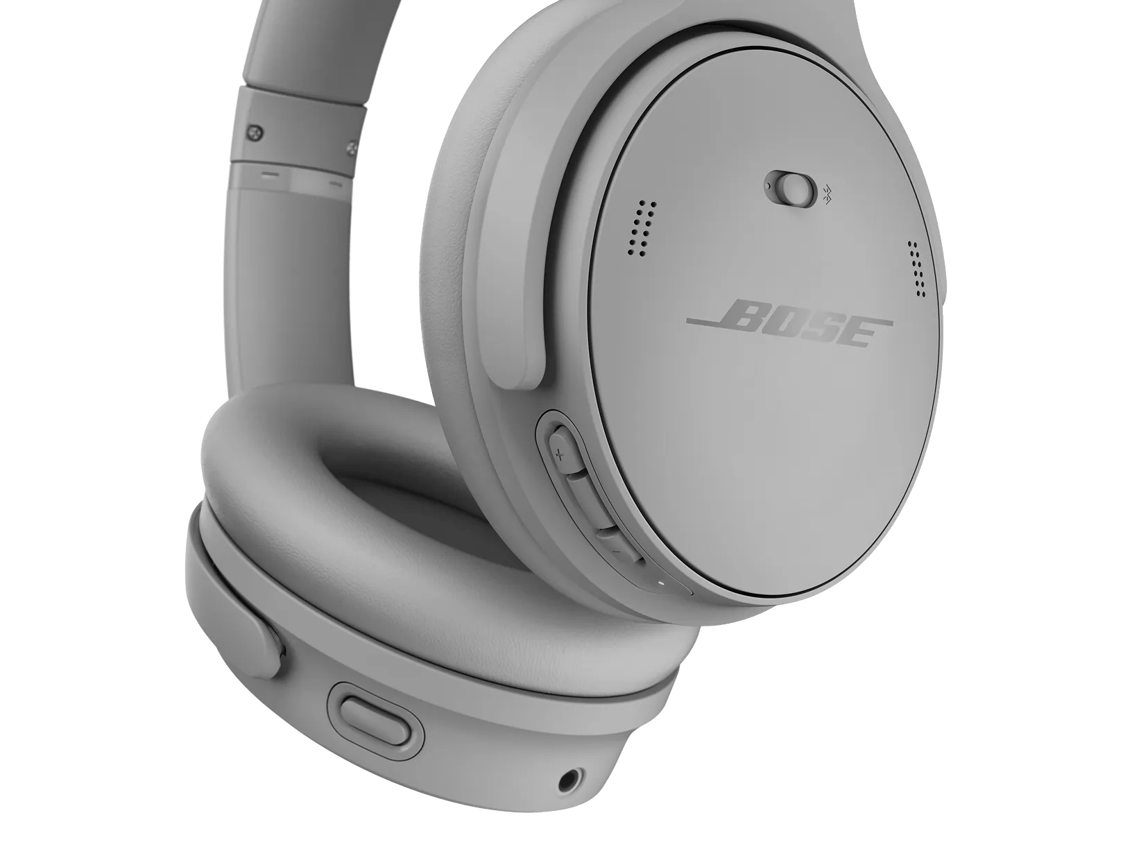 Cuffie Bose grigie. Il padiglione destro è visibile con i pulsanti e il logo Bose. Isolato su sfondo bianco.