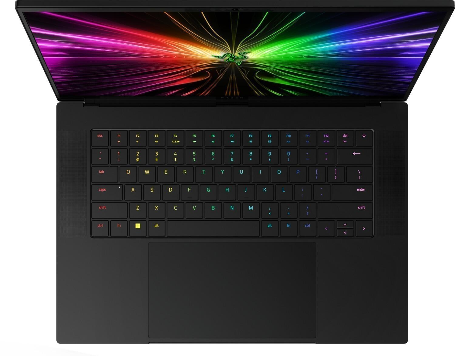 Otwarty czarny laptop, widoczna klawiatura. Ekran z kolorowym abstrakcyjnym wzorem. Logo Razer na dole.