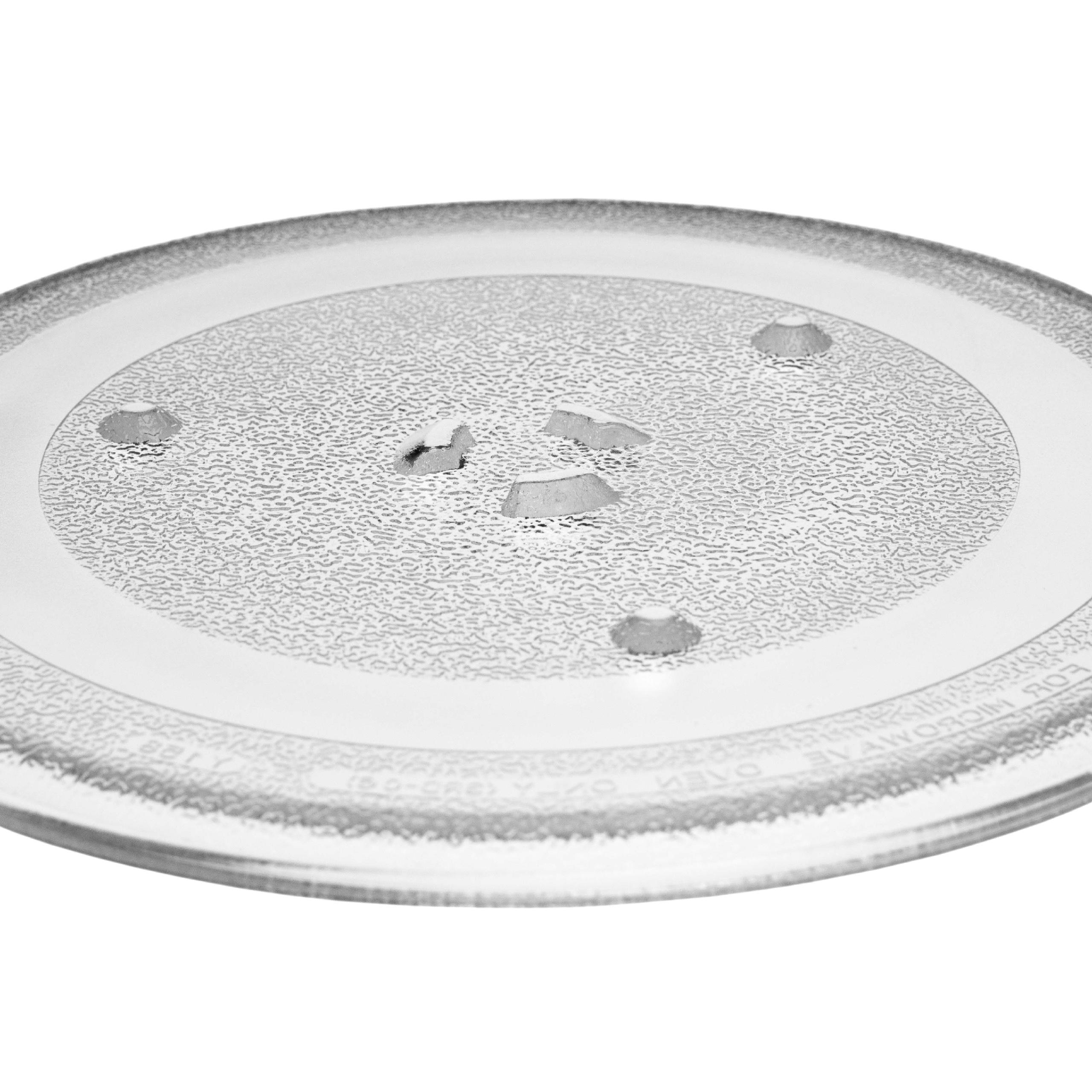 Eine klare, runde Mikrowellenplatte aus Glas mit strukturierter Oberfläche und Löchern ist zentriert.