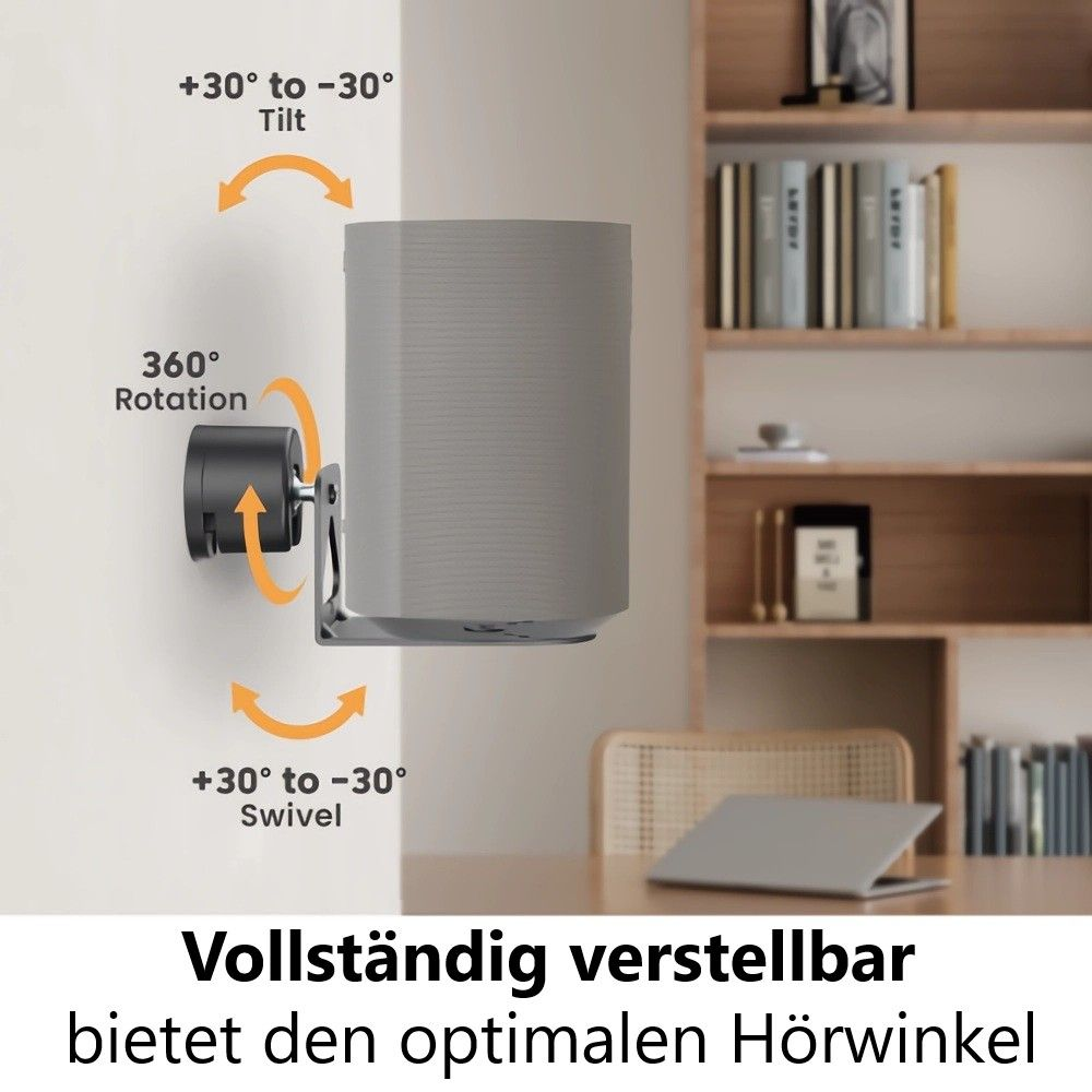 Ein grauer Lautsprecher ist an der Wand montiert und kann geneigt, gedreht und geschwenkt werden. Im Hintergrund ein Bücherregal und ein Tisch.