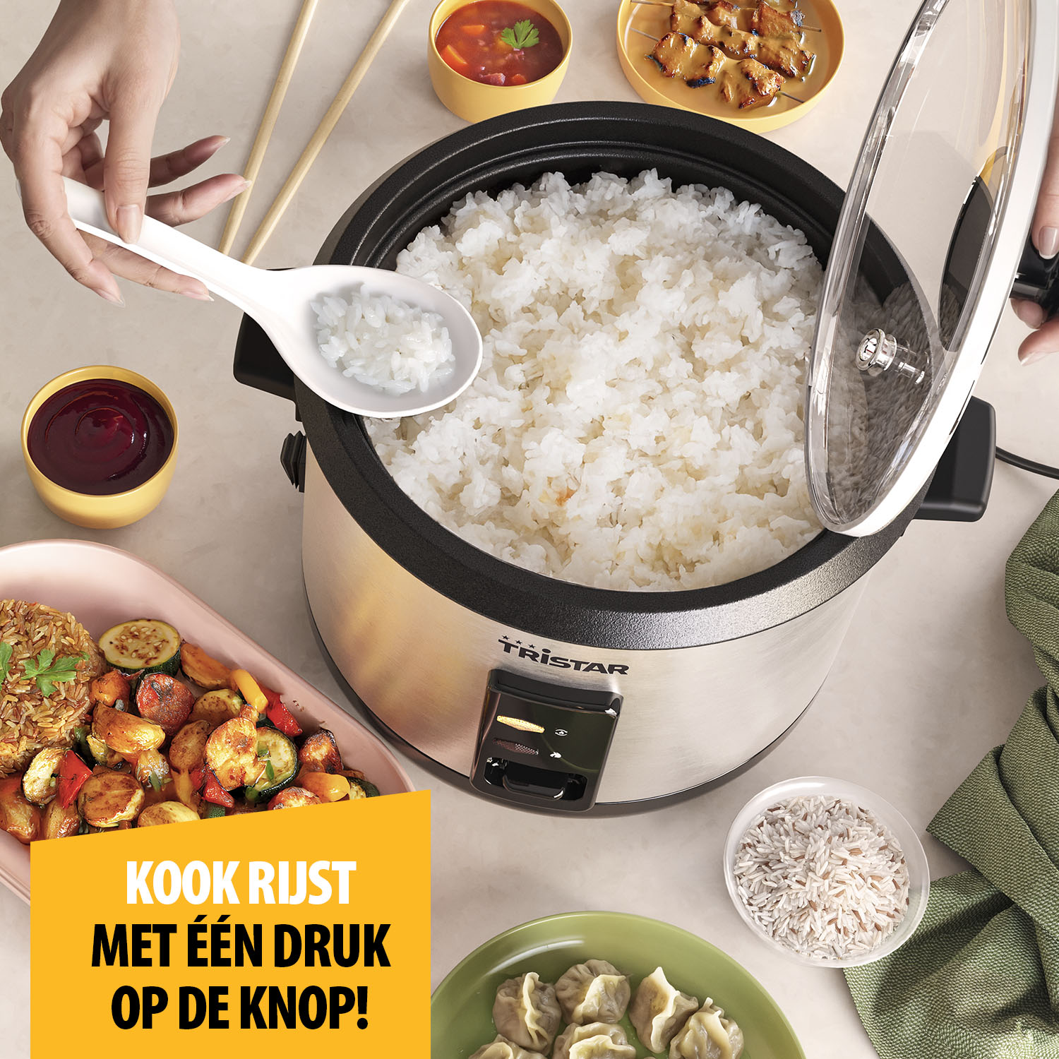 A rice cooker with cooked rice, spoon, and side dishes. Hands hold the lid and a spoon with rice. Various foods surround the cooker.