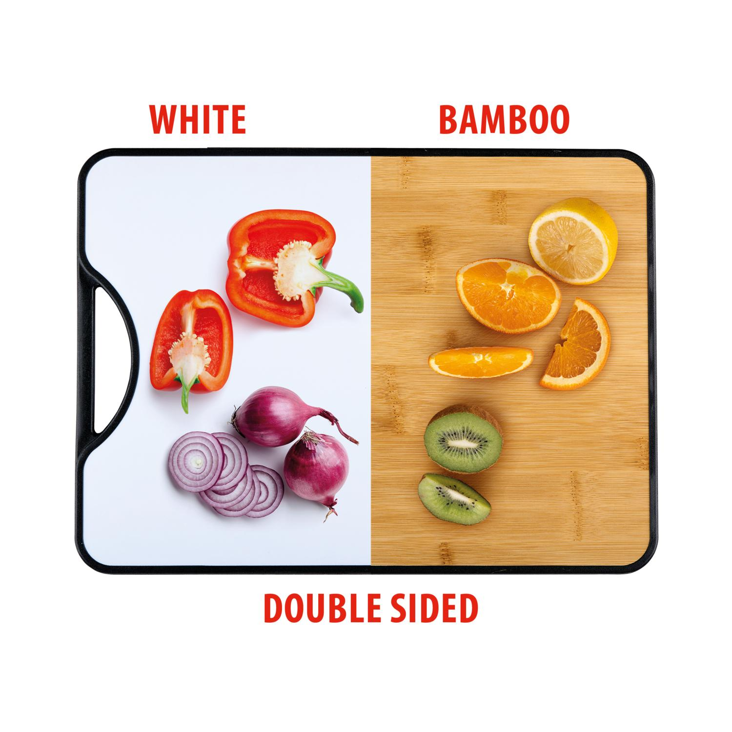 A double-sided cutting board. White side: red bell peppers, red onions. Bamboo side: orange slices, lemon, kiwi.
