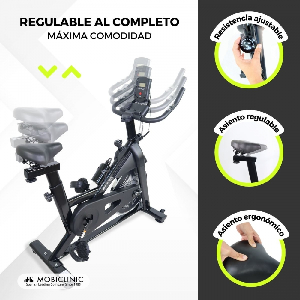 Bicicleta estática negra. Características: resistencia ajustable, asiento y diseño ergonómico. Texto: 'Ajustable al completo', 'Máxima comodidad'.