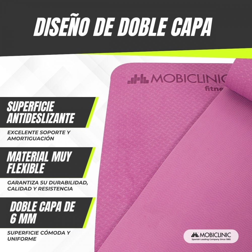 Una esterilla de yoga rosa con texto en español. Incluye la marca MOBICLINIC y características como doble capa y superficie antideslizante.
