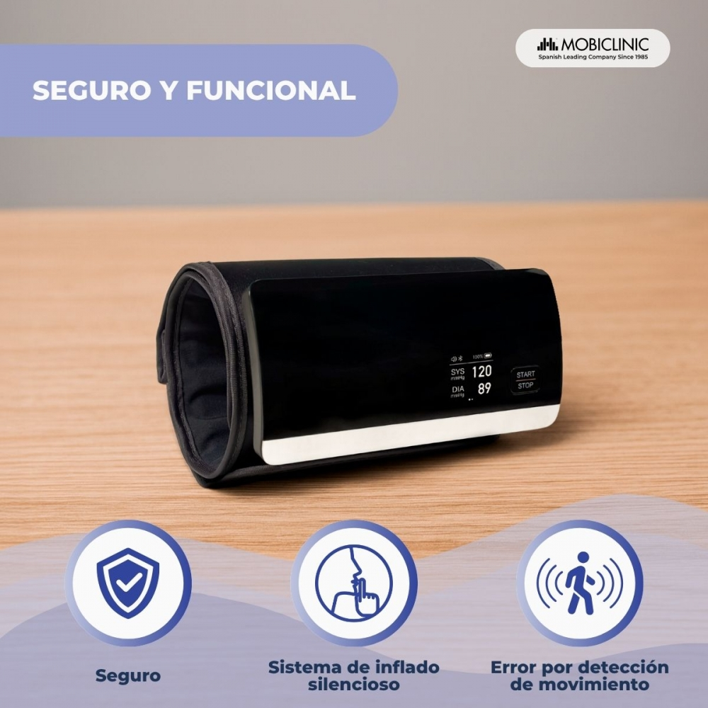 Un monitor de presión arterial negro muestra lecturas: SYS 120, DIA 89. Está sobre madera. Los iconos indican seguridad, inflado silencioso y error de movimiento.