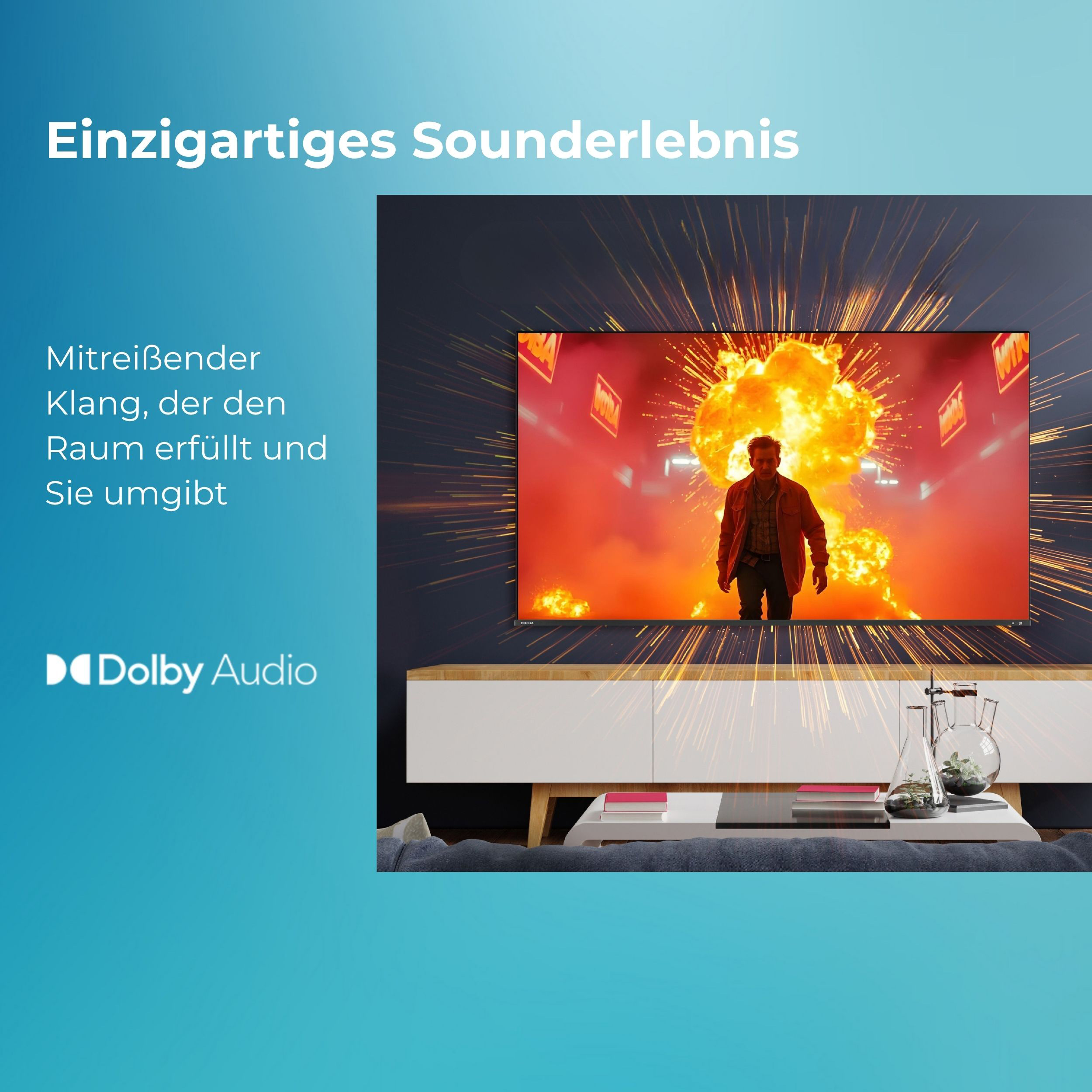 Fernseher mit Explosion. Text: einzigartiges Sounderlebnis. Mann auf dem Bildschirm, weißer Schrank darunter.