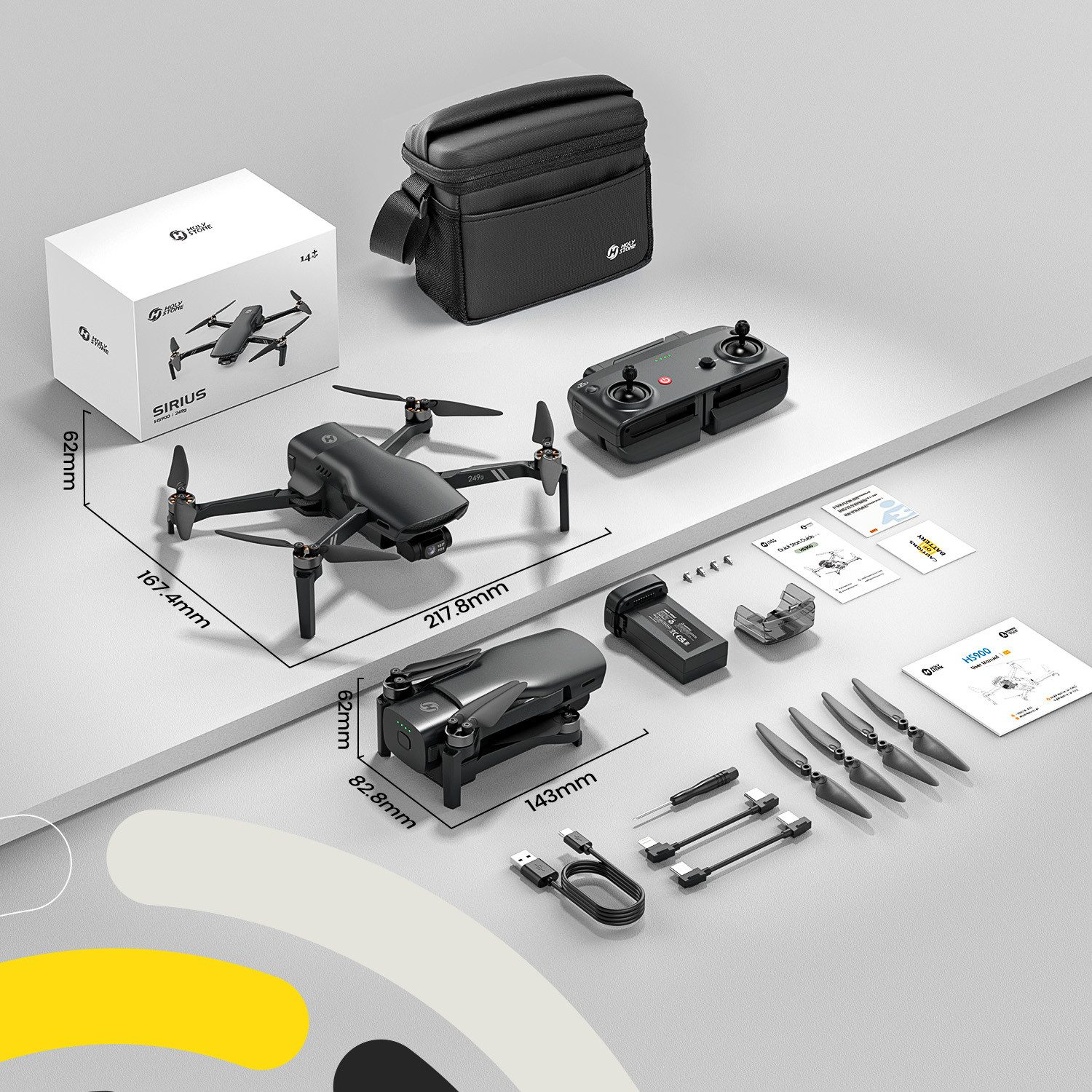 Ein Drohnen-Kit mit Drohne, Box, Tasche, Fernbedienung, Akku, Requisiten und Handbüchern auf weißem Untergrund, mit Maßen.