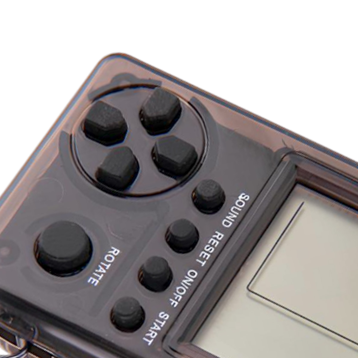 Nahaufnahme einer Handheld-Spielkonsole. Schwarze Tasten sind sichtbar: ein Steuerkreuz, Start, Ton und andere Funktionstasten.