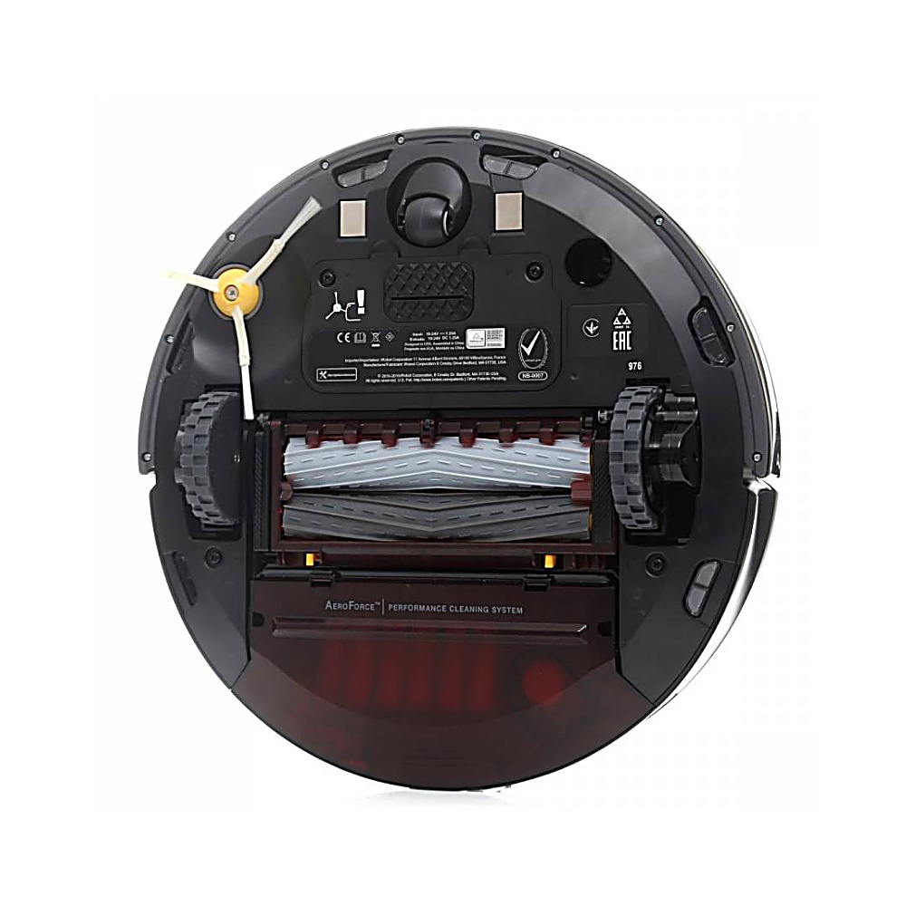 Una aspiradora robot negra. Tiene un cepillo giratorio, dos ruedas y un depósito rojo. Se ve el sistema de limpieza AeroForce Performance.