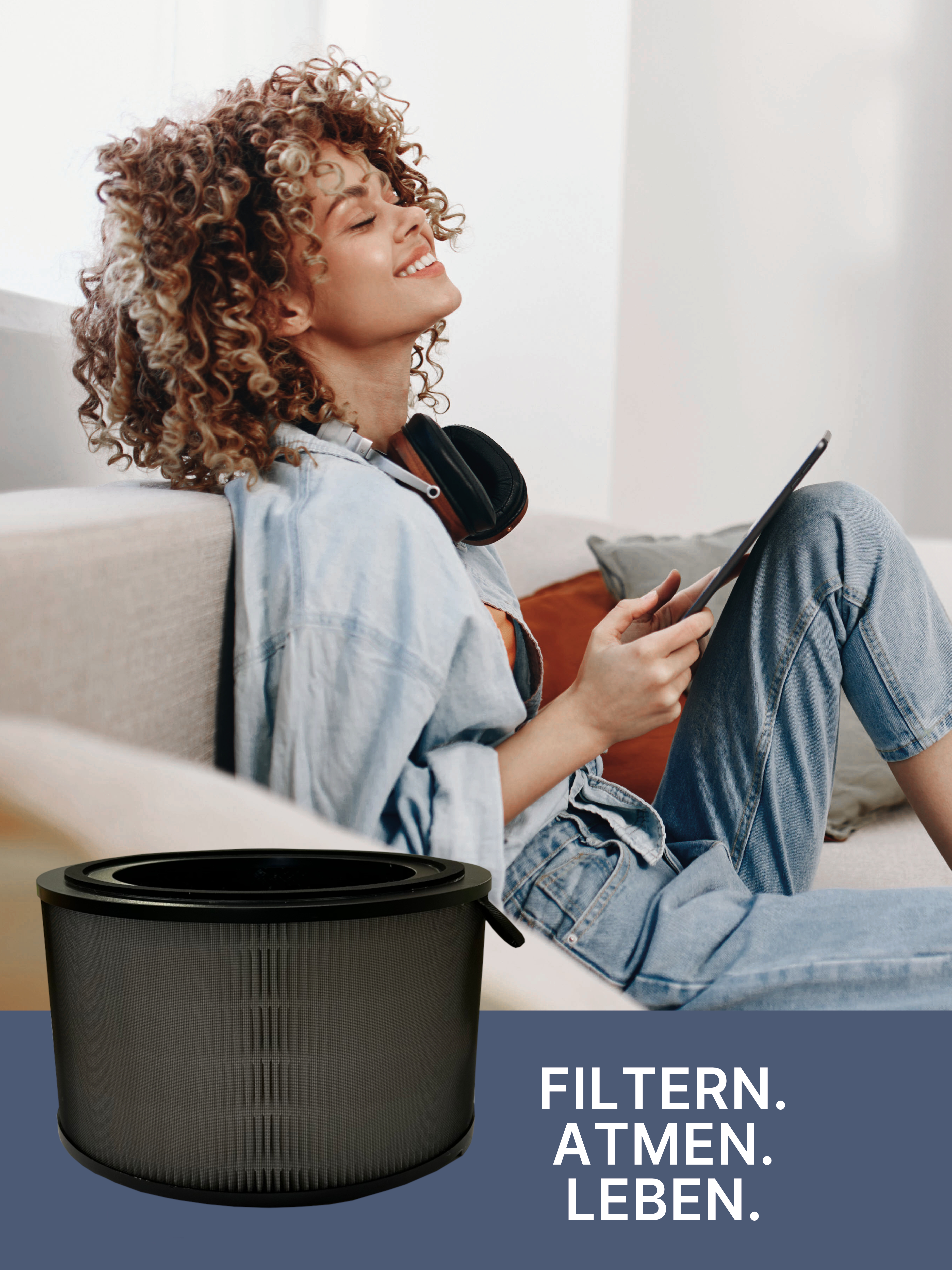 Eine Frau lächelt, während sie ein Tablet hält. Ein zylindrischer Luftfilter befindet sich im Vordergrund. Text: FILTERN. ATMEN. LEBEN.