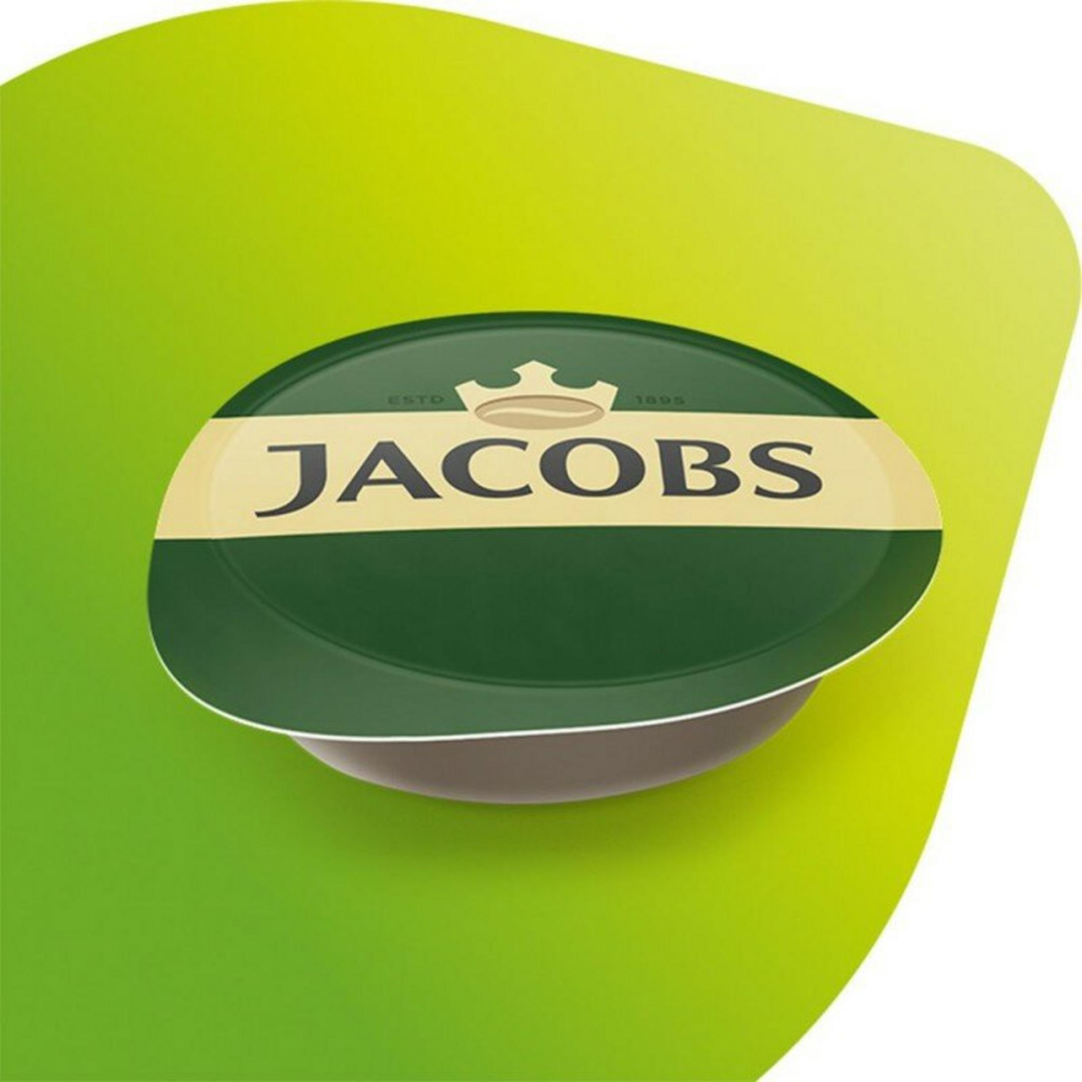 Eine grüne Jacobs Kaffeekapsel auf grünem Hintergrund. Die Kapsel hat das Jacobs-Logo und ein goldenes Band.