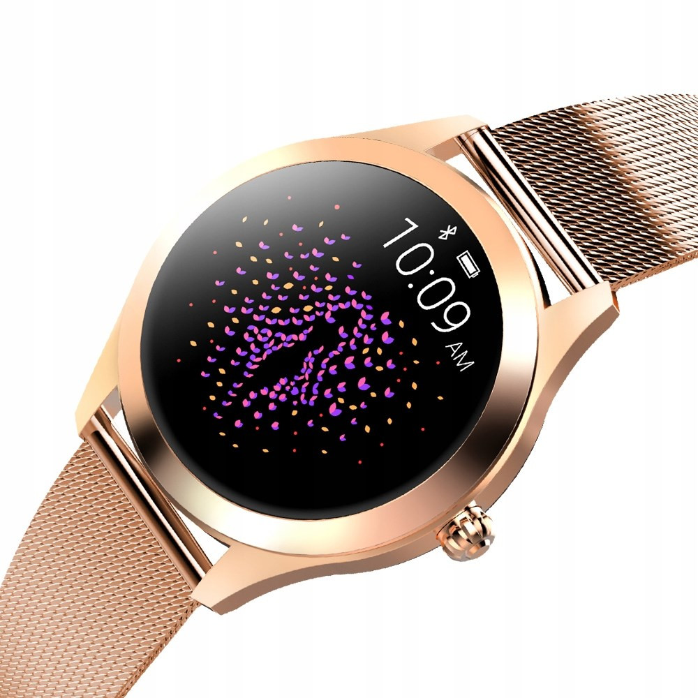 Uno smartwatch oro rosa mostra le 10:09 AM con uno schermo nero, ornato di forme astratte viola e rosa. Ha un cinturino a maglia.