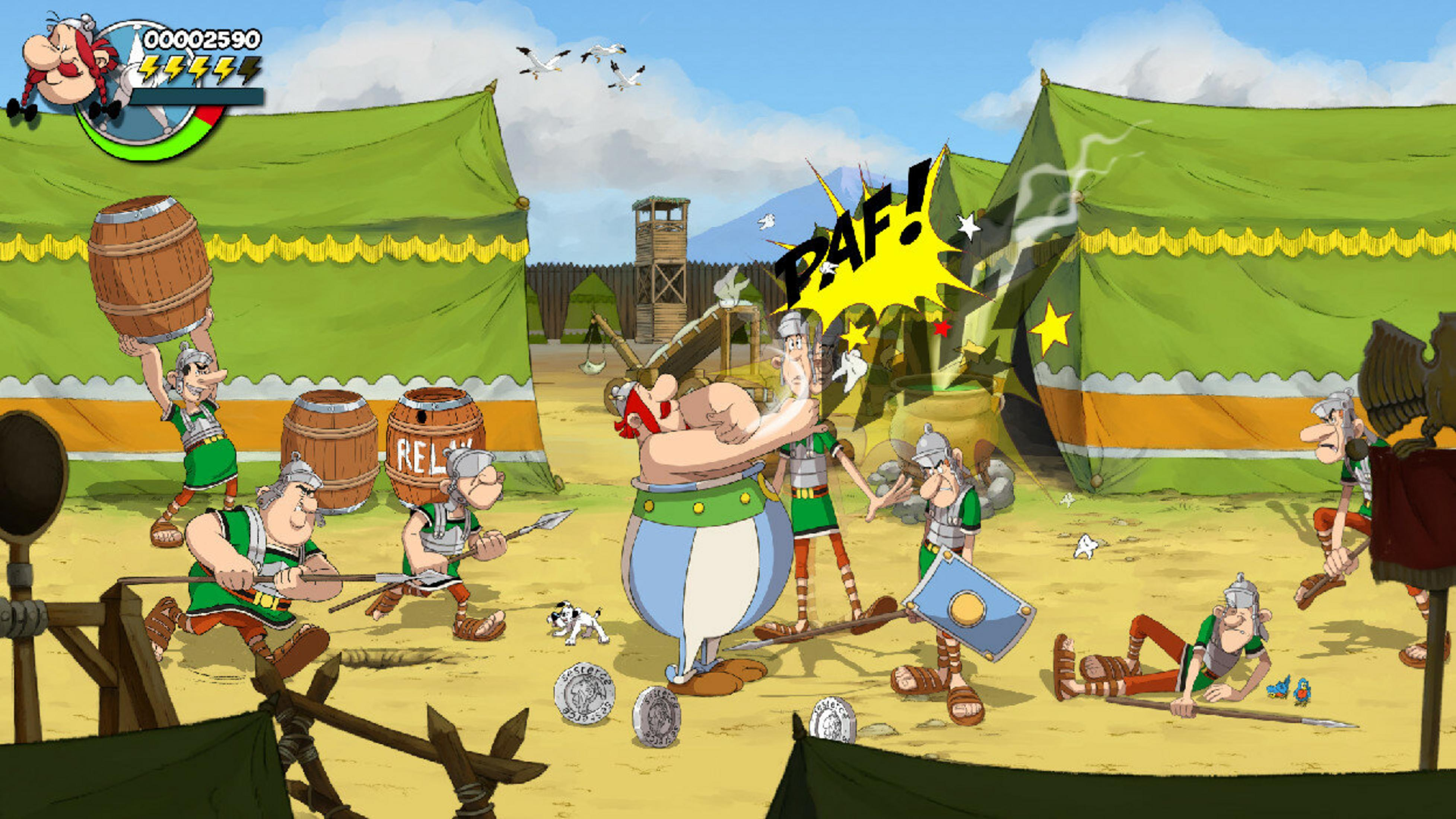 Astérix lucha contra soldados romanos. Se ven explosiones, tiendas de campaña y barriles. Un perro pequeño y monedas en el suelo.