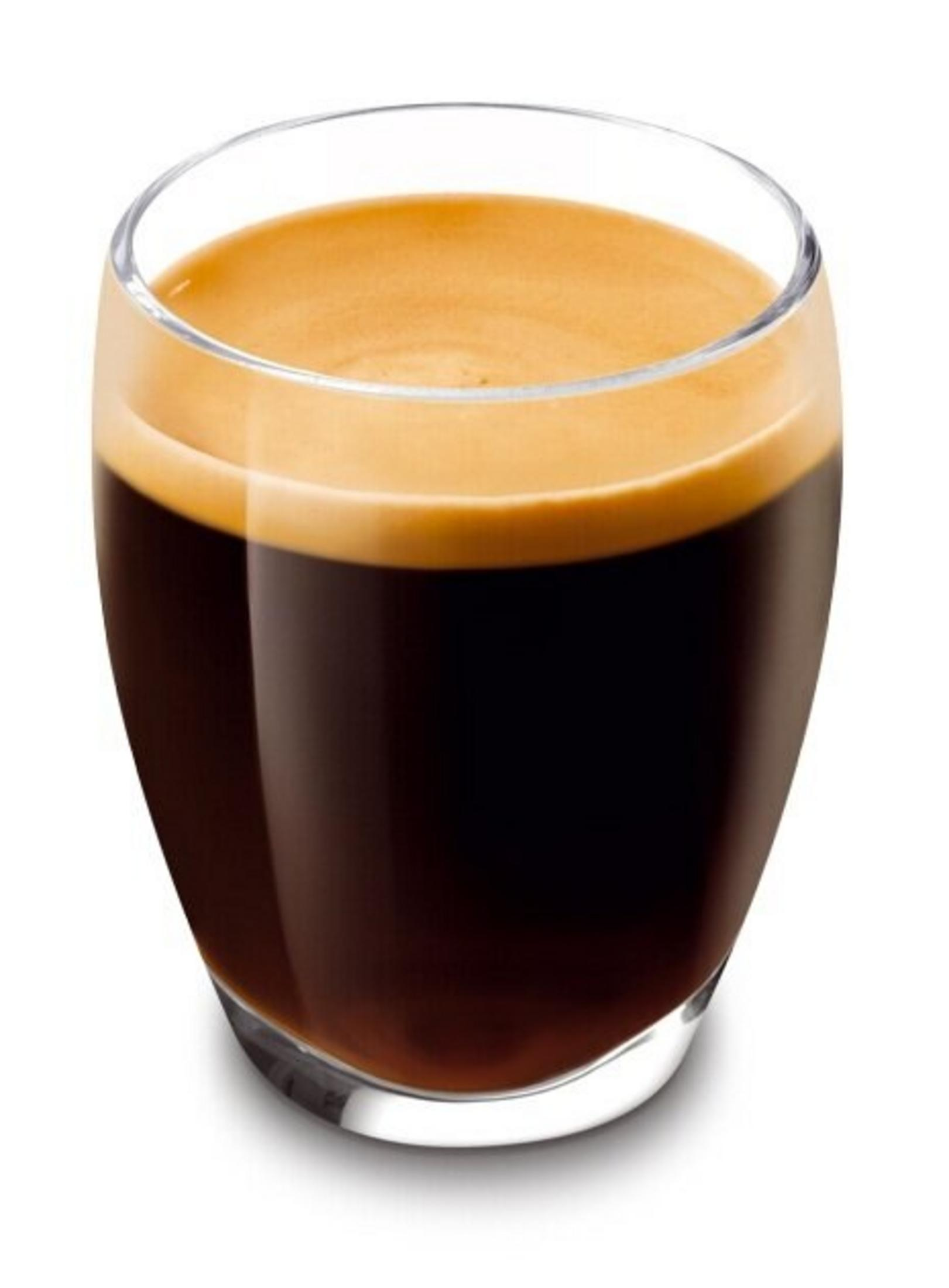 Zbliżenie szklanki espresso. Kawa jest ciemnobrązowa z warstwą pianki na wierzchu.