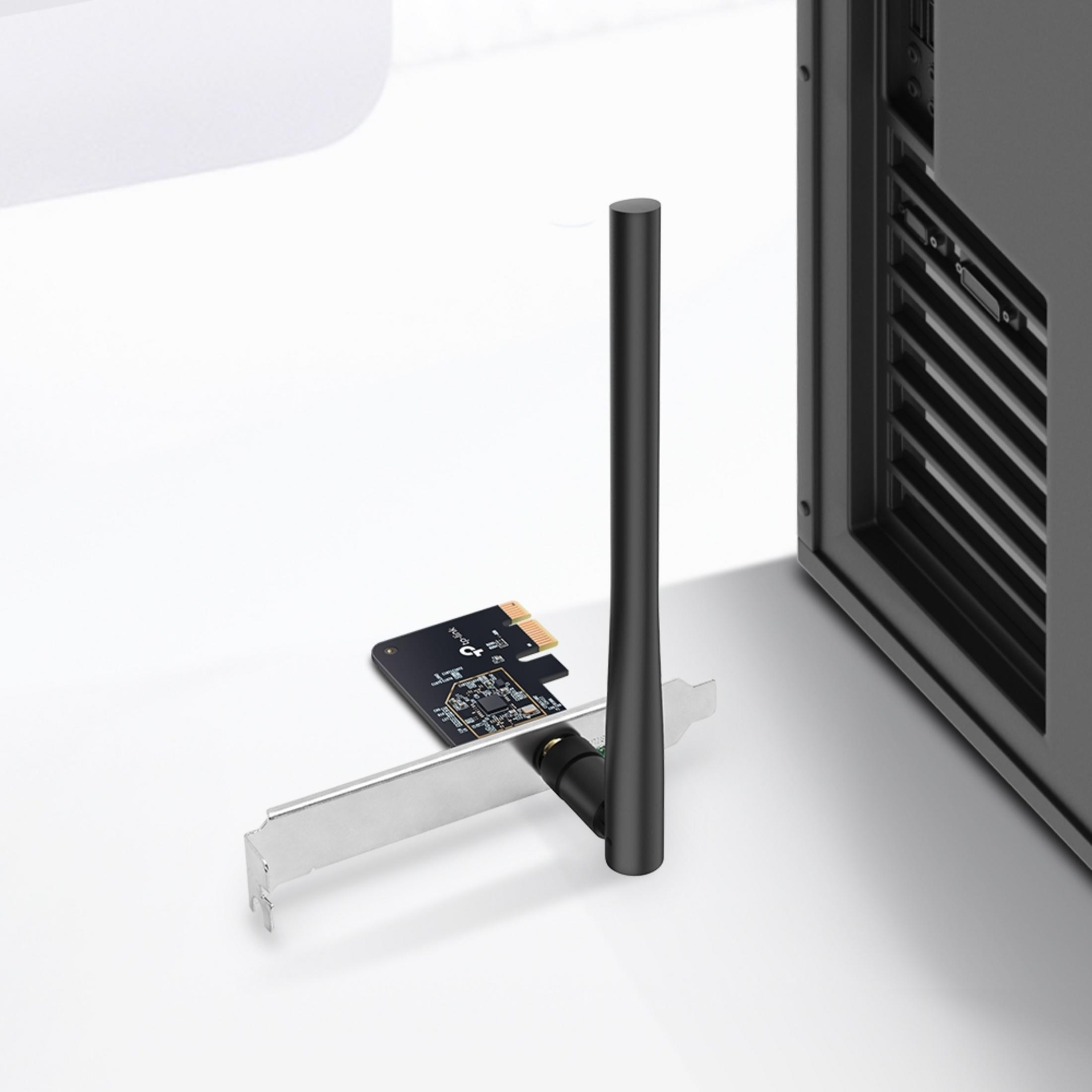 A computer component with an antenna is placed in front of a computer case on a white surface.