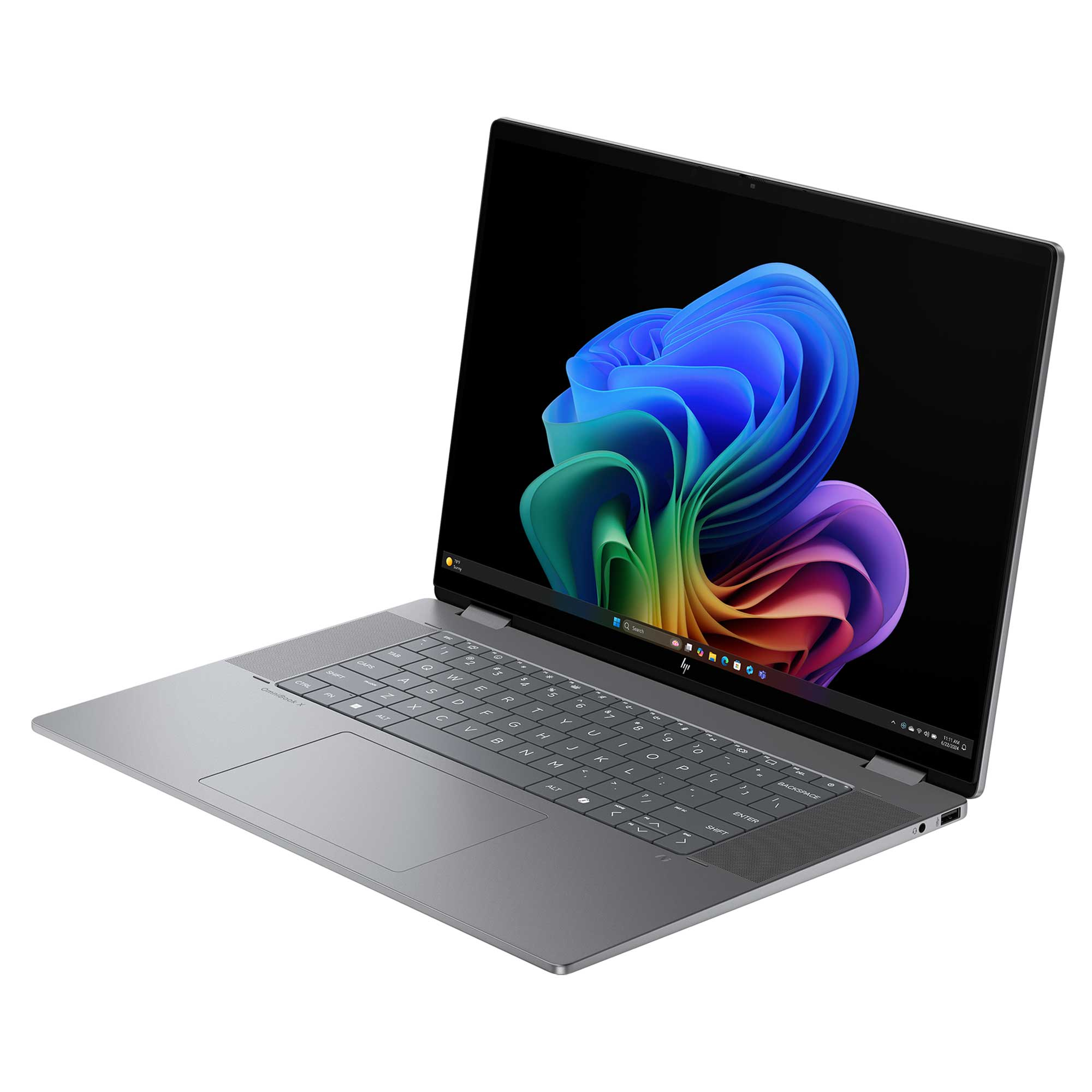 Gri bir HP dizüstü bilgisayar açık. Ekran, renkli, soyut bir Windows arka planı gösteriyor. Klavye görünür.