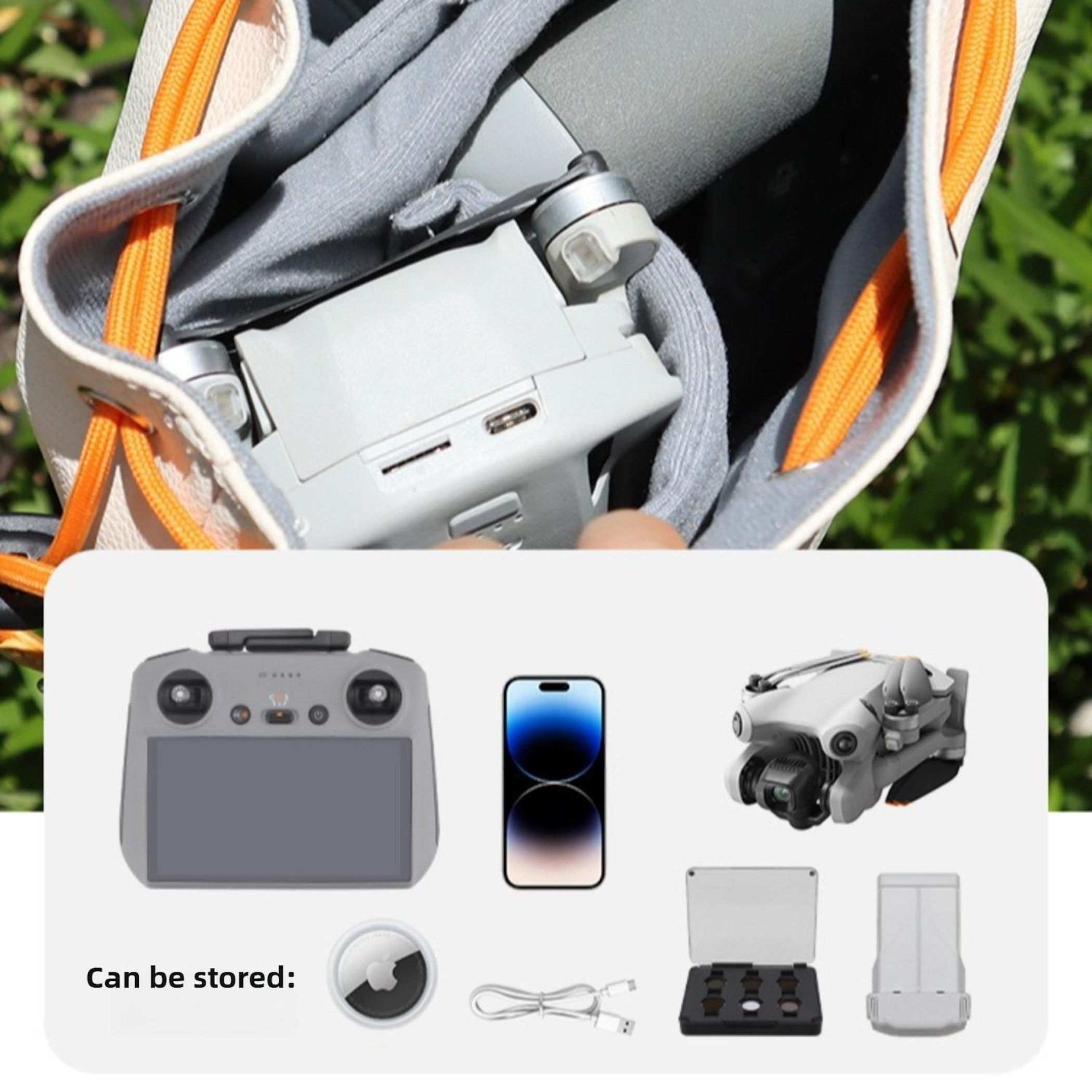 Drohne und Zubehör in einer Tasche. Enthält Controller, Telefon, Filter, Ladegerät und einen Anhänger. Alle Artikel auf weißem Untergrund.
