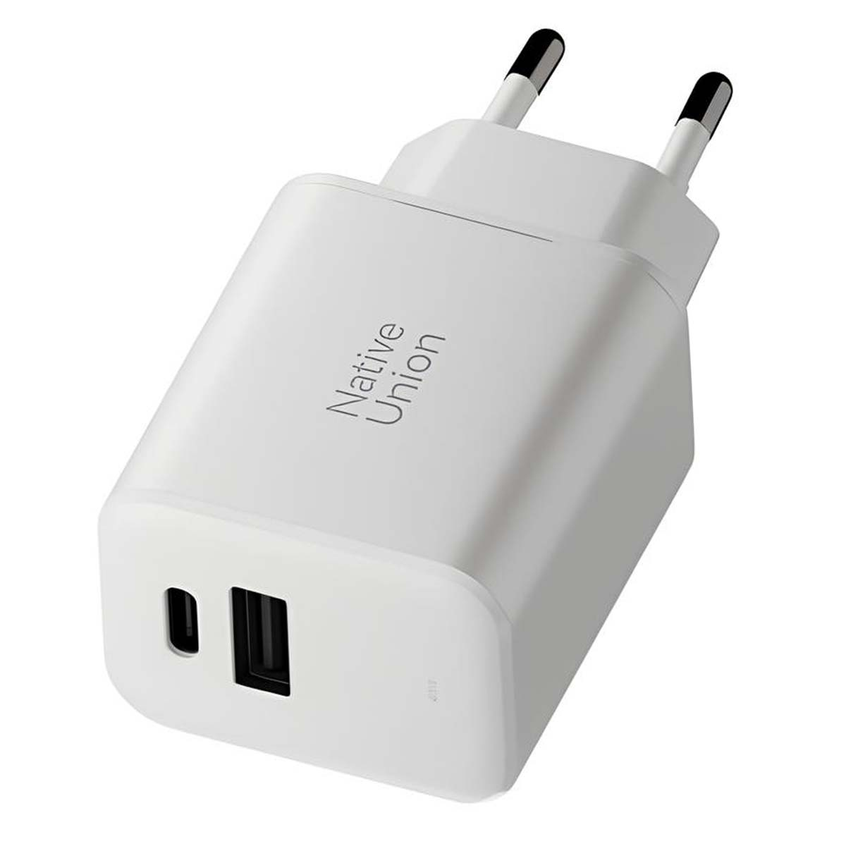 Ein weißes Native Union USB-Ladegerät mit zwei Stiften und einem USB-Anschluss. Der Markenname ist aufgedruckt.