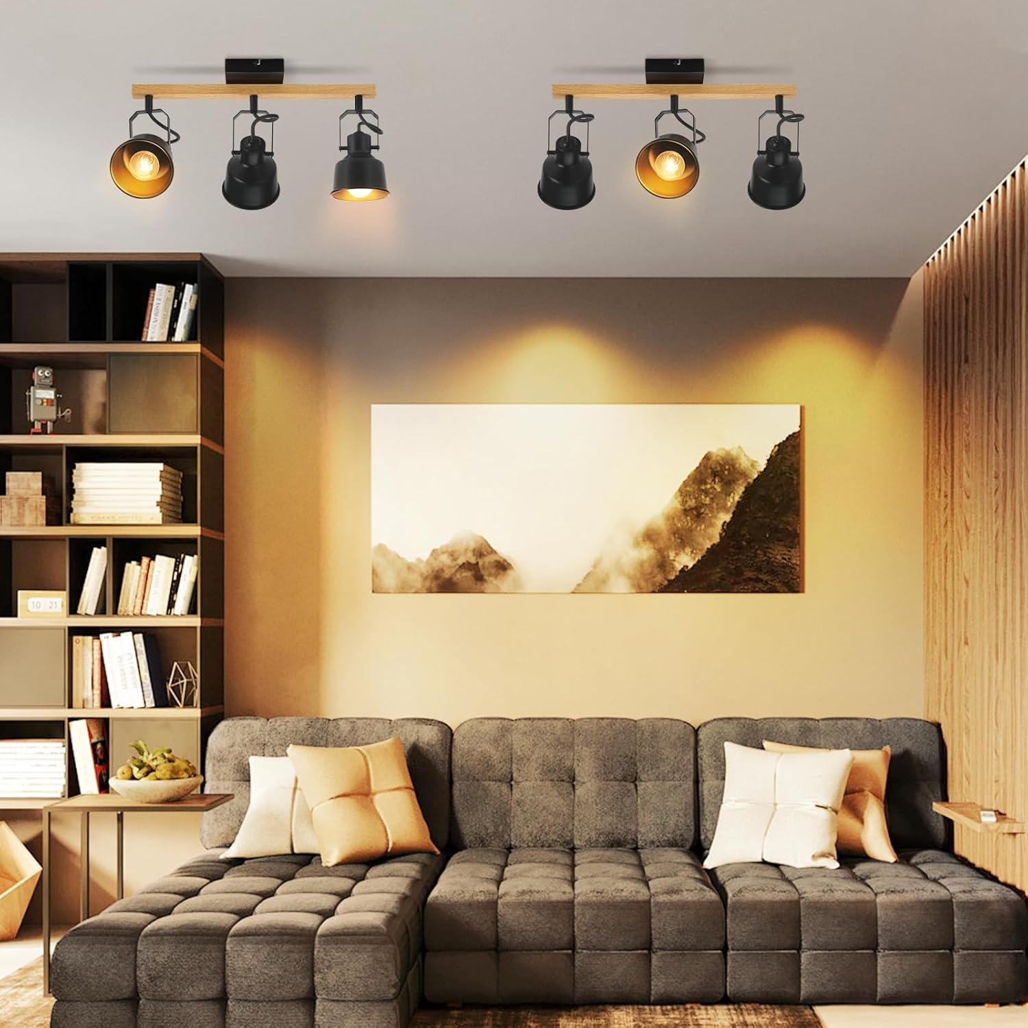 Nowoczesny salon z szarą sofą narożną, drewnianymi lampami sufitowymi i obrazem krajobrazu.