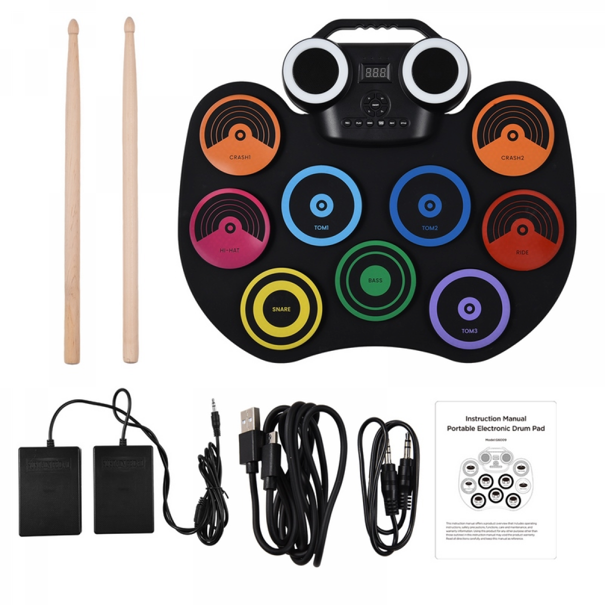 Elektronisches Schlagzeug mit Drumsticks, Fußpedalen, Kabeln und Bedienungsanleitung. Schwarzes Drum-Pad mit beschrifteten Bereichen.