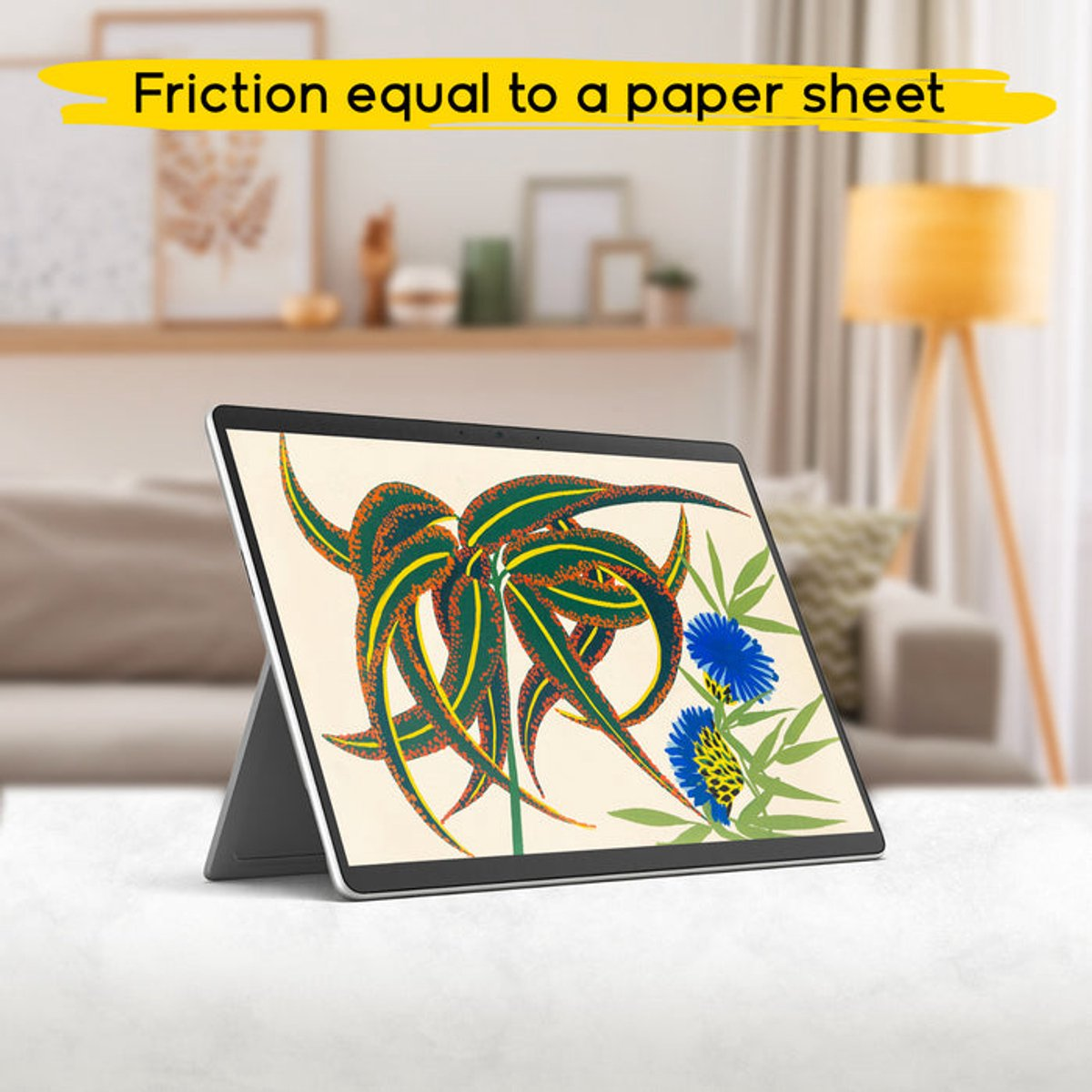 Tableta con diseño floral. Texto amarillo arriba: 'Fricción igual a una hoja de papel'. El fondo muestra una habitación.