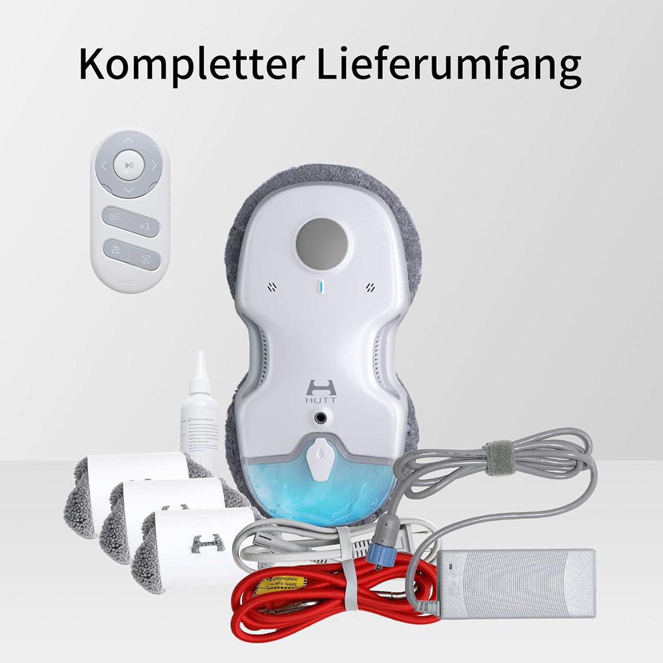 Un robot de nettoyage de vitres blanc avec accessoires comme télécommande, tampons et adaptateur secteur, sur fond clair.