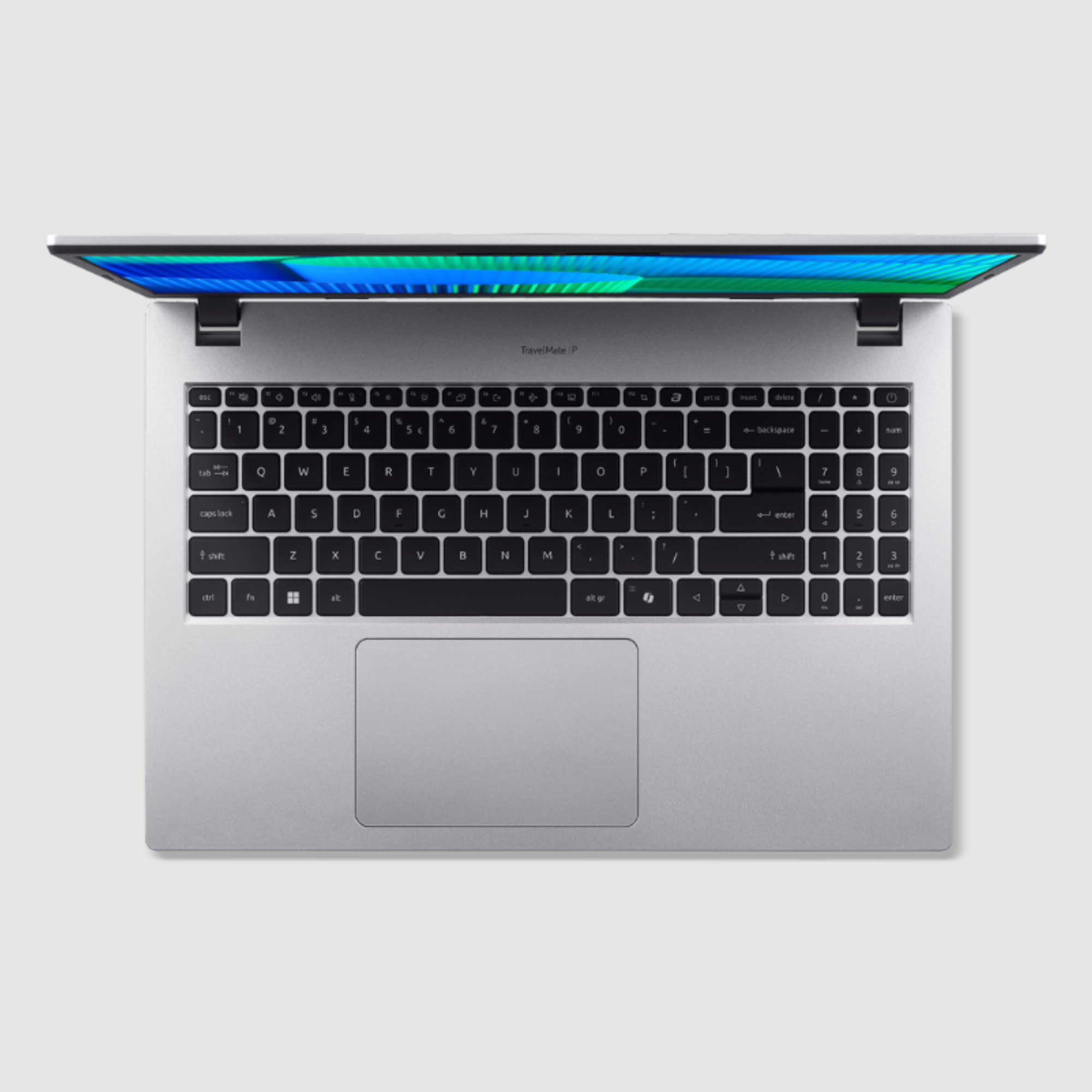 Ein silberner Laptop ist geöffnet und zeigt Tastatur und Bildschirm. Der Bildschirm zeigt blaue und grüne Farben.