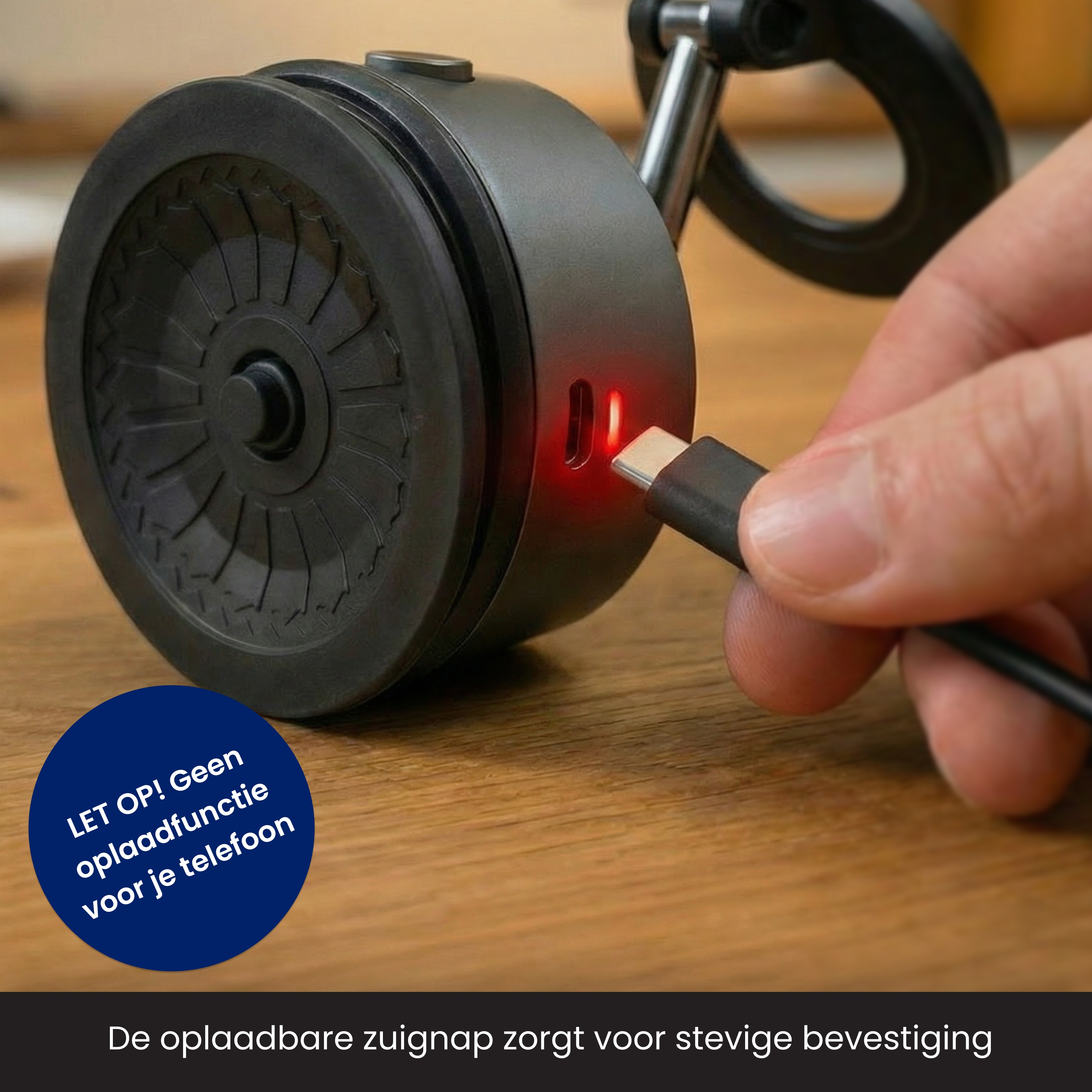 A dark device with a charging port and a hand inserting a cable. The device has a circular design.