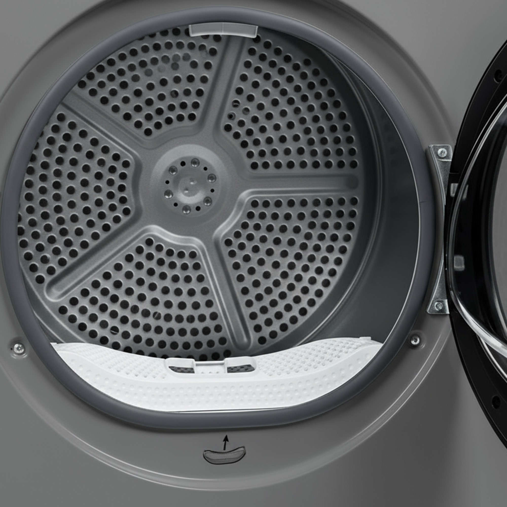 Inside of a gray dryer. The perforated drum is open, with a white lint trap at the bottom.
