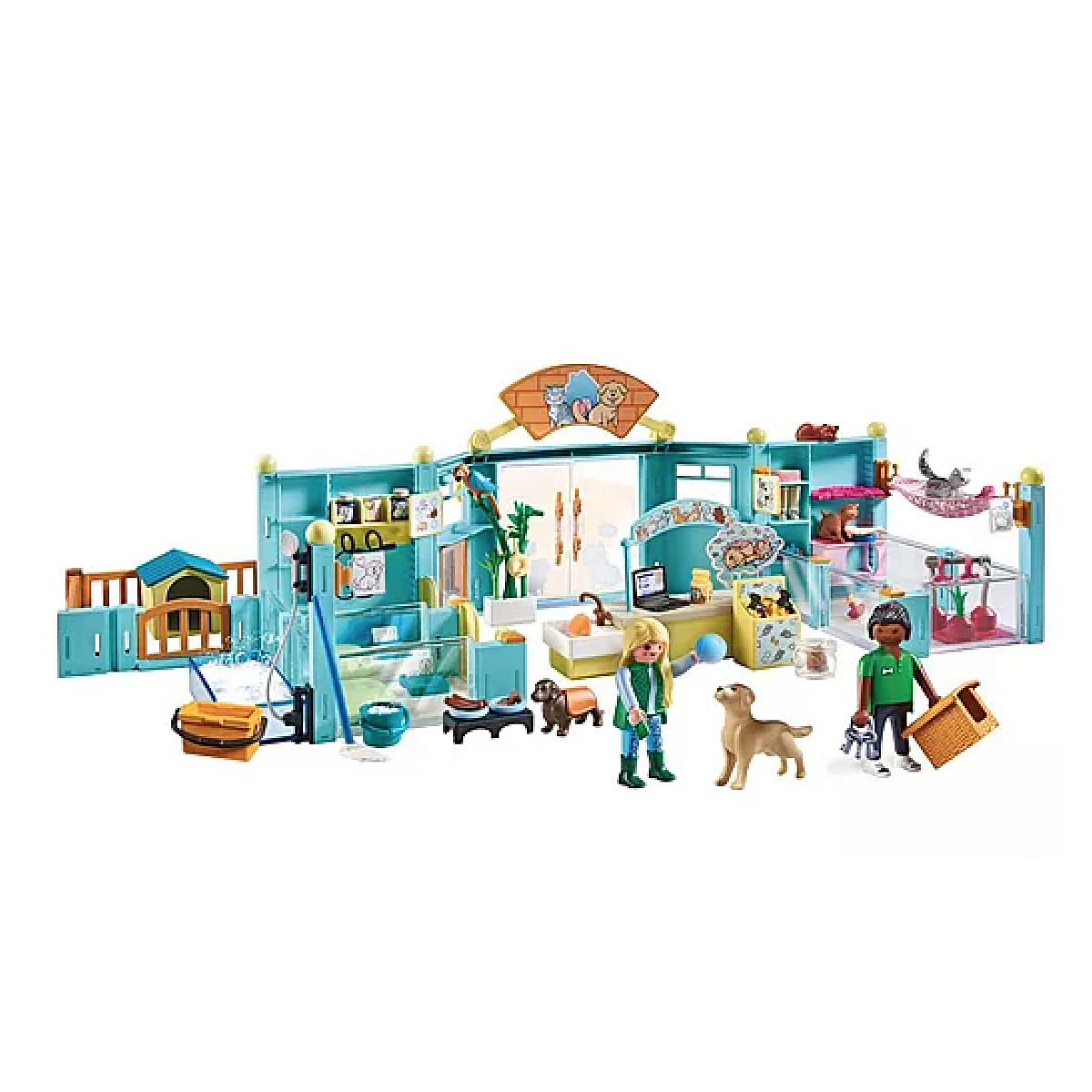 Un refugio para mascotas de juguete con figuras, perros, gatos y accesorios. Hay dos personas, un perro y exhibiciones de gatos.