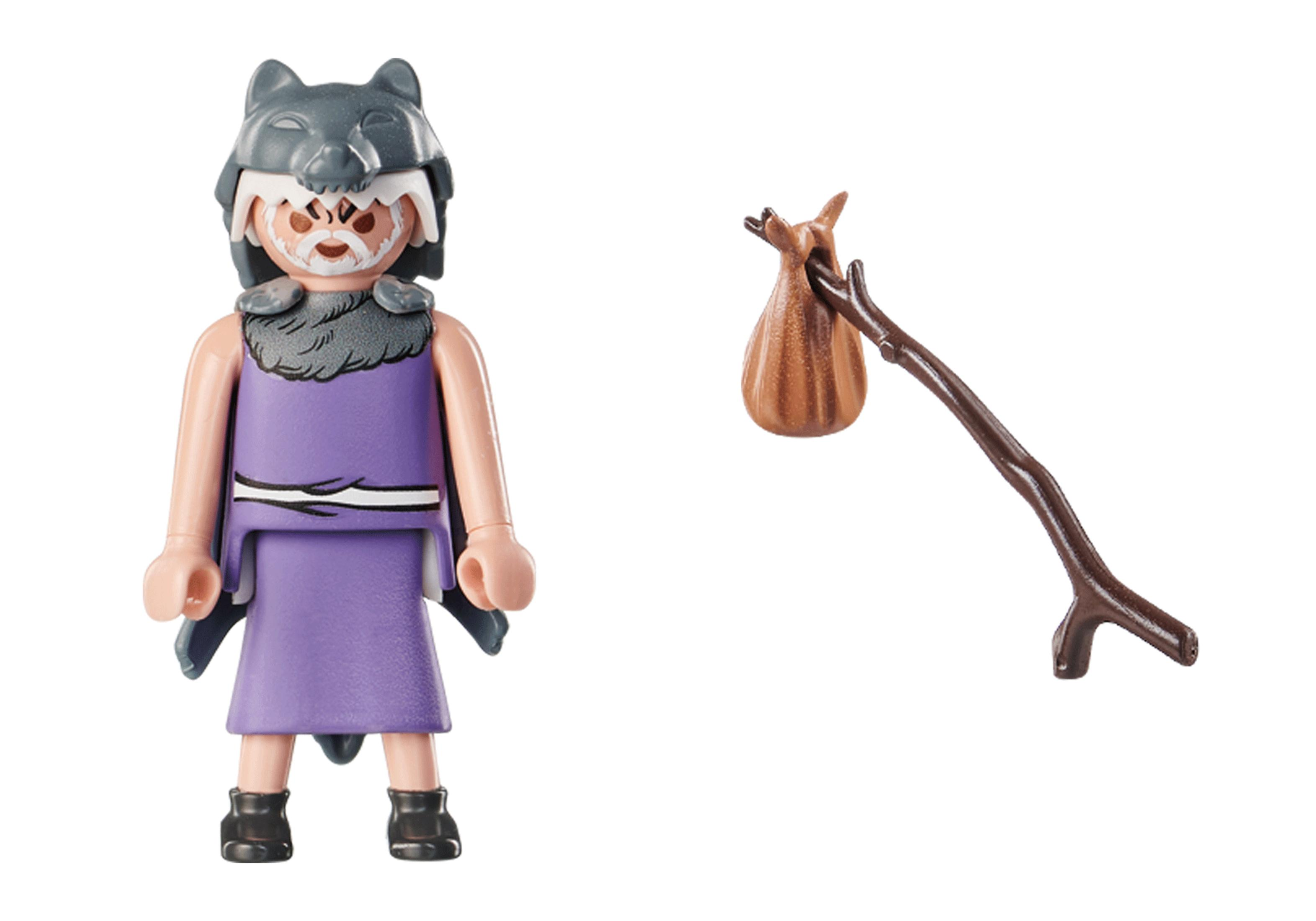 A Playmobil figure wearing a wolf headdress and purple tunic, holding a brown stick with a sack.