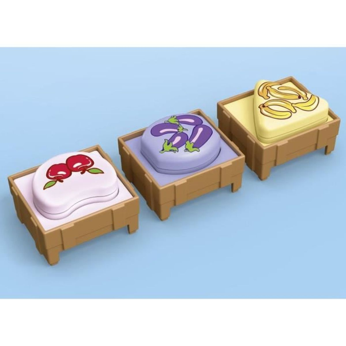 Tre casse giocattolo con illustrazioni di frutta. Ciliegie, melanzane e banane sono mostrate su sfondi bianchi o gialli.